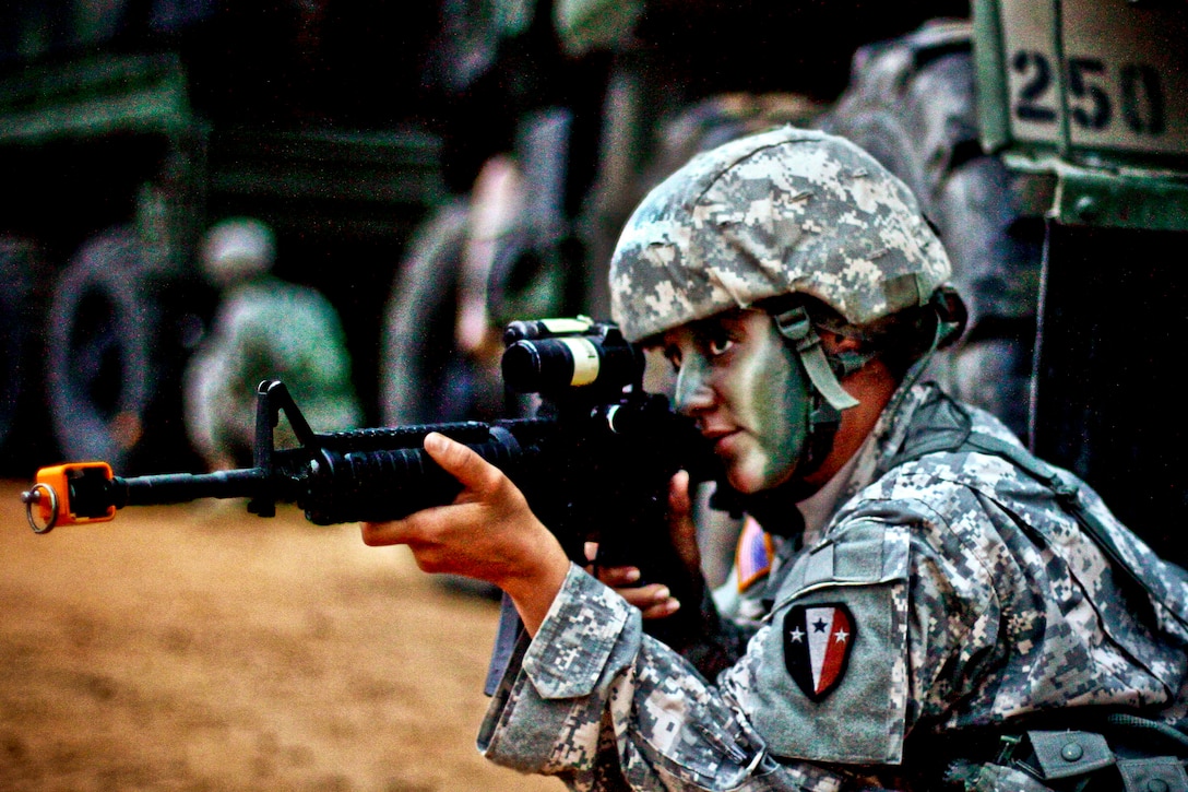 Army Spc. Nancy Reid scans the area for threats while providing security for a convoy during a field training exercise on Fort Pickett, Va., Aug 17, 2013. Reid is assigned to the New Jersey Army National Guard's 250th Brigade Support Battalion, 50th Infantry Brigade Combat Team.  
