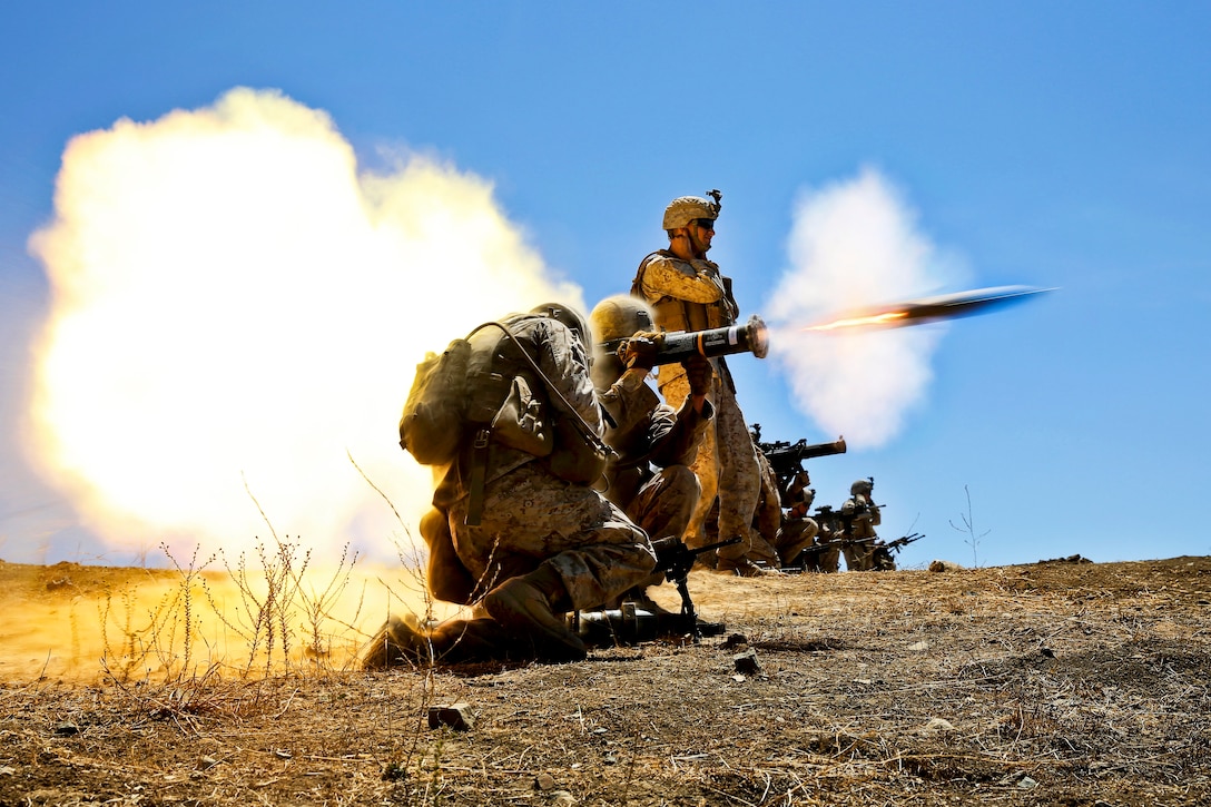 Marine Corps Lance Cpl. Pablo Ruiz, center, engages a target with an antiarmor weapon on Marine Corps Base Camp Pendleton, Calif., Aug. 12, 2013. Ruiz, a rifleman, is assigned to Echo Company, 2nd Battalion, 5th Marine Regiment. The company conducted platoon attacks, reinforced by a combined antiarmor team, mortar fire and machine gun fire.  
