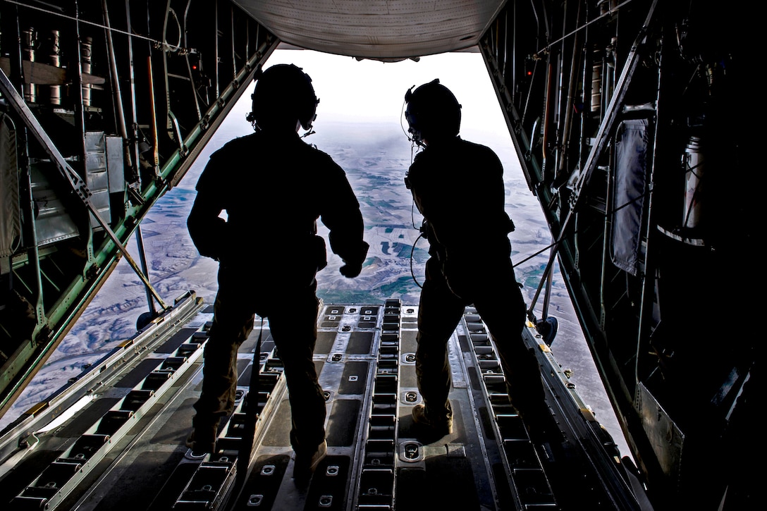 U.S. Air Force Airman 1st Class Michael R. Brown II, left, and Air Force Airman 1st Class Marcus Kraatz, right, check the seal around a C-130's ramp after releasing cargo during an airdrop mission over Afghanistan, Aug. 2, 2013. Brown and Kraatz, aircraft loadmasters, are assigned to the 774th Expeditionary Airlift Squadron.  
