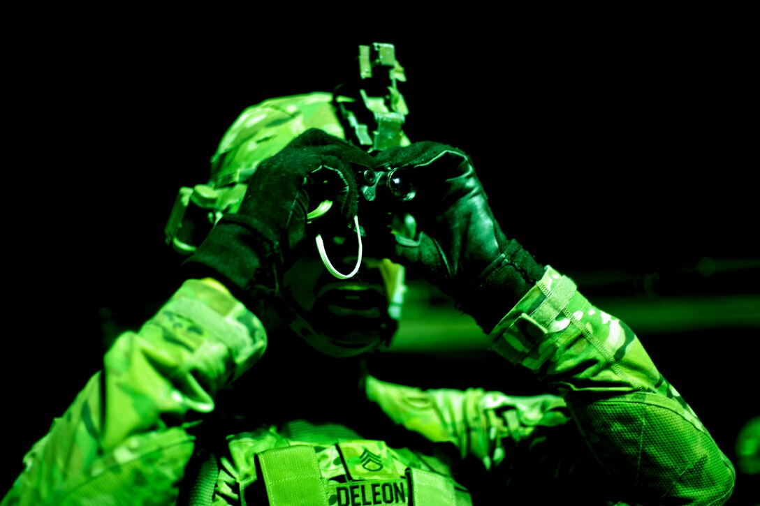 As seen through a night-vision device, U.S. Army Staff Sgt. Mark Deleon checks his personal optic device during marksmanship training on Firebase Maholic, Bagram Airfield, Parwan province, Afghanistan, Aug. 11, 2013. Deleon is assigned to the 1st Cavalry Division's Company D, 1st Battalion, 5th Cavalry Regiment, 2nd Brigade Combat Team.  
