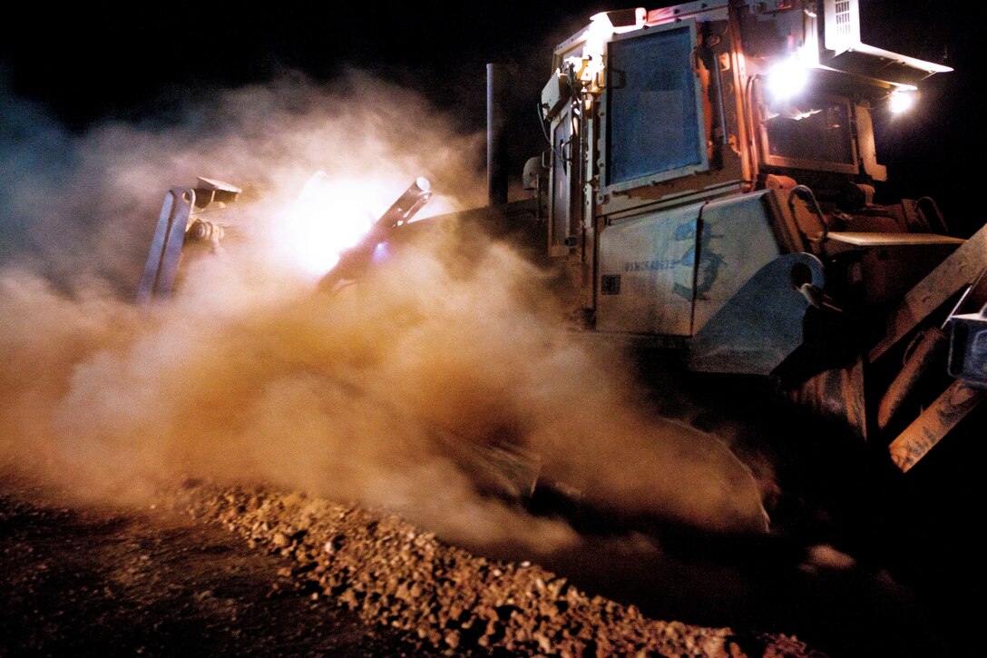 A U.S. Marine operates a bulldozer during a project to upgrade security Camp Dwyer in Helmand province, Afghanistan, Aug. 7, 2013.  
