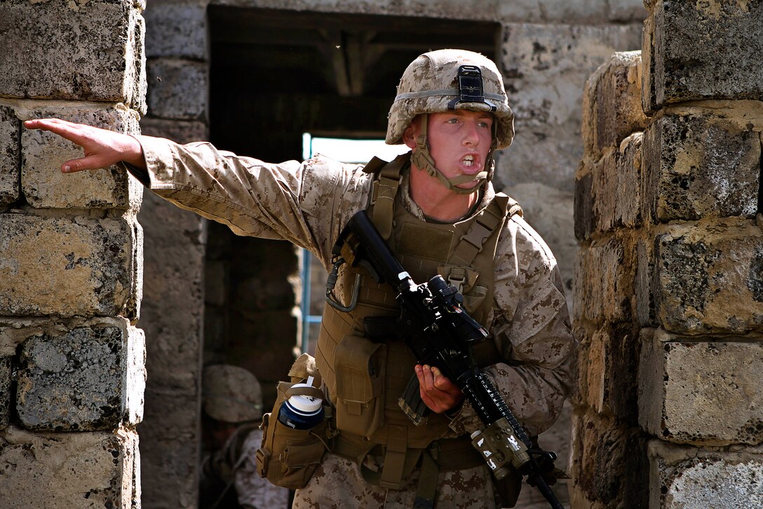 U.S. Marine Corps Lance Cpl. Nicholas Moore shouts orders to his team during a cordon and search event during Exercise Khaan Quest 2013 at Five Hills Training Area in Mongolia, Aug. 08, 2013. Moore is assigned to the 3rd Marine Division's 3rd Battalion, 3rd Marine Regiment. The United States and Mongolia sponsor the annual exercise to strengthen the capabilities of U.S., Mongolian and other forces in international peace support operations.  
