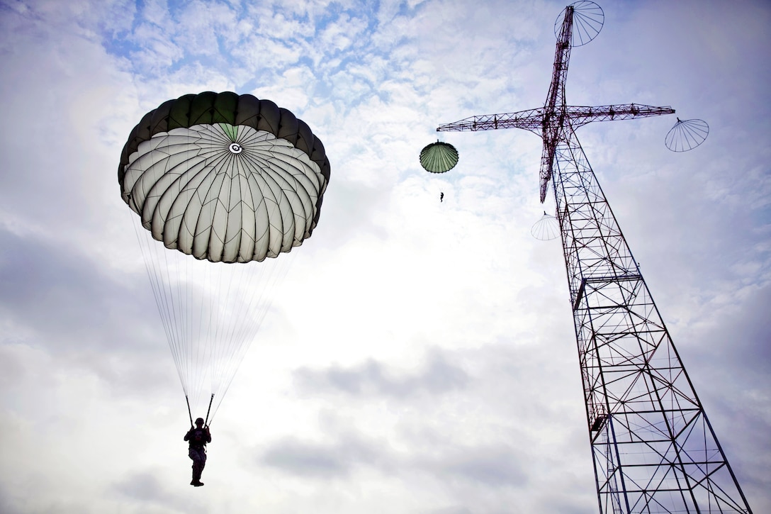 A soldier is dropped from the 250-foot tower with a T-10 parachute during training at U.S. Army Airborne School on Fort Benning, Ga., Aug. 7, 2013. The course includes three phases: ground week, tower week and jump week.  

