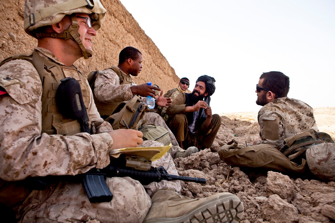 U.S. Marines and Georgian troops meet with an Afghan man during a patrol in Charibaya in Afghanistan's Helmand province, Aug. 8, 2013. Coalition forces patrolled to meet with Afghans in the area and investigate the terrain. The Georgian troops are assigned to Liaison Team 9 and the 33rd Light Infantry Battalion.  
