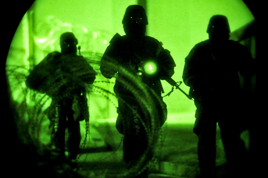 Airmen respond to a ground attack during Beverly Midnight 13-03, an operational readiness exercise on Osan Air Base, South Korea, Aug. 8, 2013. The exercise is designed to test the base's ability to defend and execute the mission in a heightened state of readiness. The airmen are members of the 51st Security Forces Squadron.  
