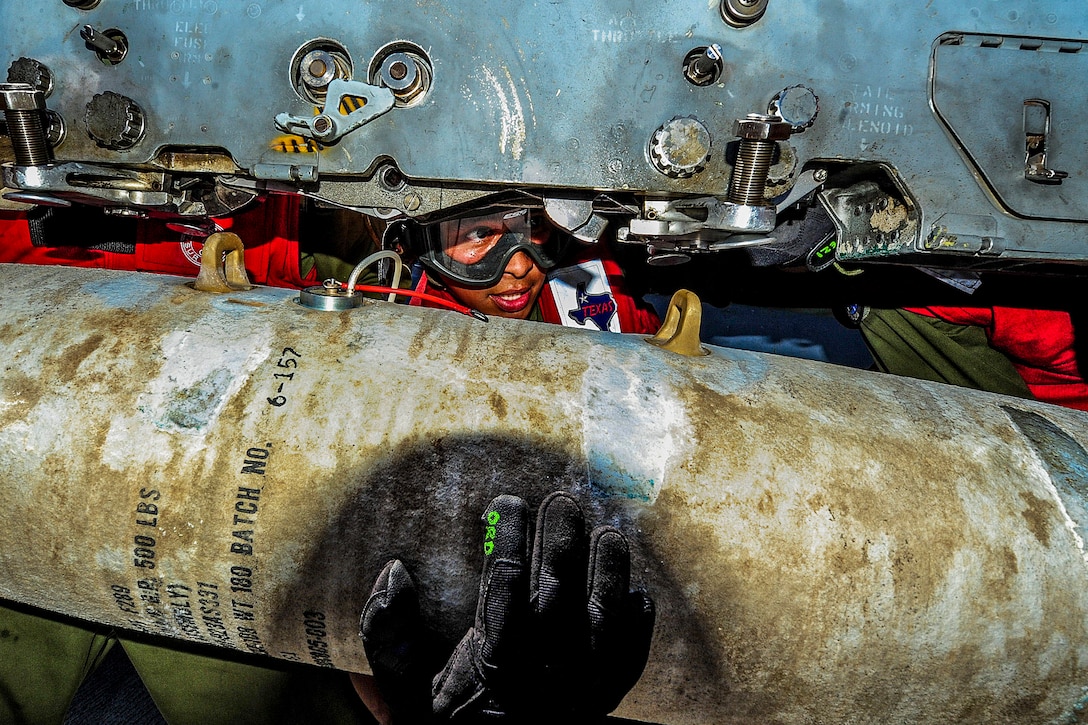 U.S. Marine Corps Lance Cpl. Tony Hernandez attaches a direct attack munition to an AV-8B Harrier II aboard the amphibious assault ship USS Boxer in the Pacific Ocean, Aug. 2, 2013. The Boxer Amphibious Ready Group is underway off the coast of Southern California completing an exercise to certify the readiness of the 13th Marine Expeditionary Unit and the amphibious group to conduct integrated missions.  
