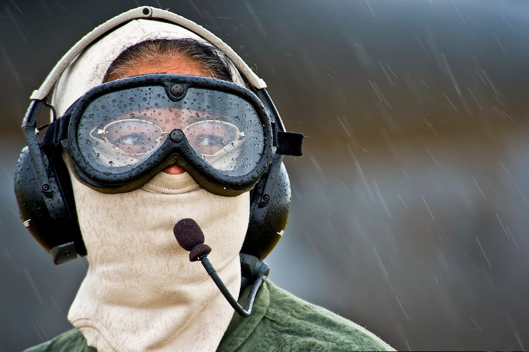 U.S. Air Force Capt. Tracy Tucker endures cold and rainy conditions while working as a safety spotter during Global Medic 2013, an exercise on Fort McCoy, Wis., July 27, 2013. The U.S. Air Force and Army reserves participate in the exercise, which is designed to replicate all aspects of combat medical service support. Tucker is a flight nurse with the 433rd Aeromedical Evacuation Squadron.  
