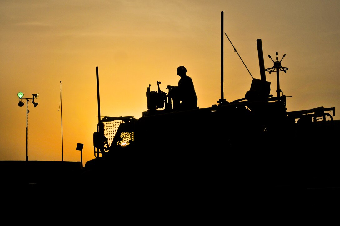 U.S. Army Spc. Carlos Tapia checks a crew system equipped with a machine gun before convoy operations on Kandahar Airfield, Afghanistn, July 30, 2013. Tapia is assigned to Alpha Troop, Regimental Support Squadron, Combined Force Dragoon, which provided security during the operation.  
