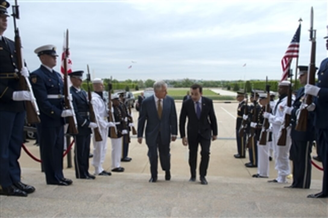 U.S. Defense Secretary Chuck Hagel, left, escorts Georgian Defense Minister Irakli Alasania through an honor cordon at the Pentagon, May 7, 2014. The two leaders met to discuss issues of mutual importance.