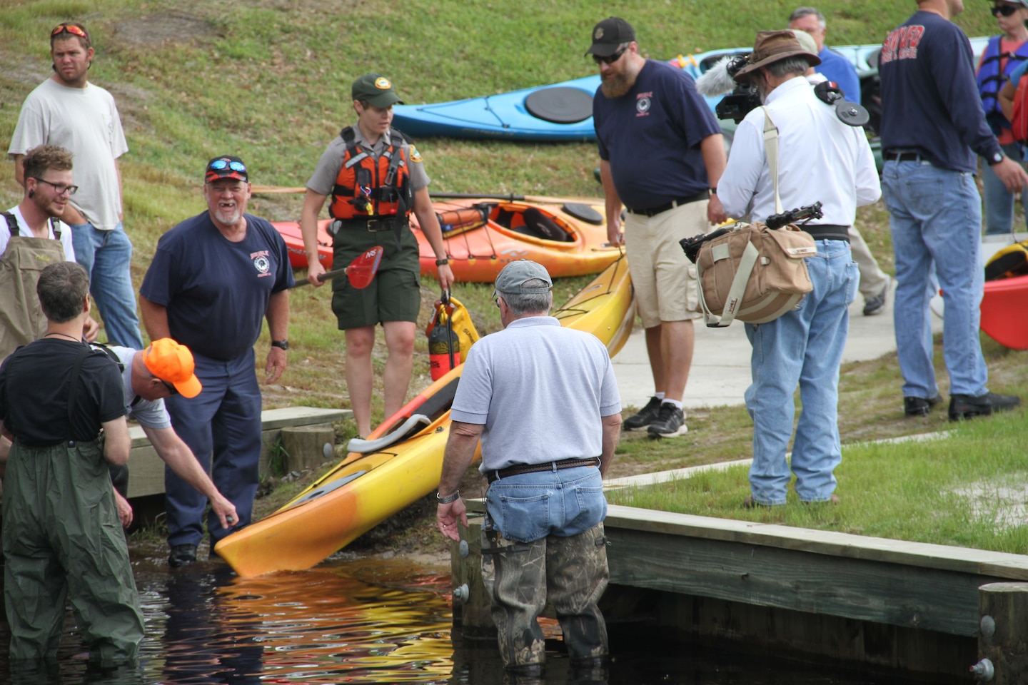 SOUTH MILLS, NORTH CAROLINA -- Under dew-covered trees and leafy vegetation, volunteers welcomed 350 participants at the Dismal Swamp Canal Welcome Center in North Carolina with muffins and juice as the paddlers mingled and talked about their kayaks, custom-made canoes and put on this year’s lime-green Paddle for the Border T-shirt. 