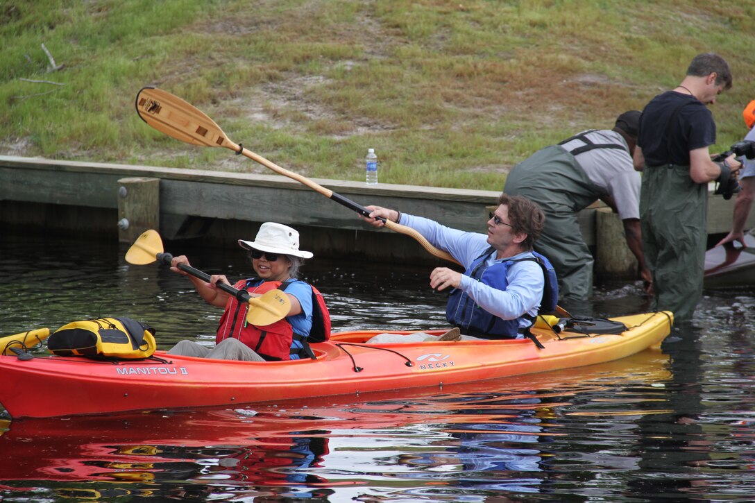 SOUTH MILLS, NORTH CAROLINA -- As kayaks, canoes and water boards launched in North Carolina at 8:30 a.m., temperatures had crept to the mid-70s for the 11-mile paddle to Virginia. Massive trees arching over the water and small coves provided shady retreats for people to stop, sip water and snap photos of their friends paddling by. 