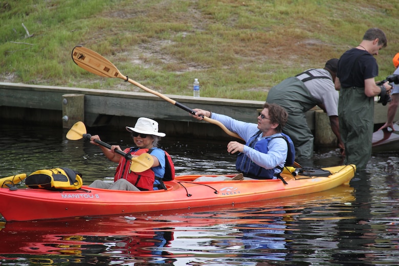 SOUTH MILLS, NORTH CAROLINA -- As kayaks, canoes and water boards launched in North Carolina at 8:30 a.m., temperatures had crept to the mid-70s for the 11-mile paddle to Virginia. Massive trees arching over the water and small coves provided shady retreats for people to stop, sip water and snap photos of their friends paddling by. 