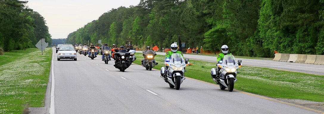 Police officers from across Eastern North Carolina escort more than 300 service members during the Live Hard, Ride Free motorcycle poker ride aboard Marine Corps Base Camp Lejeune, May 2. The ride kicked off National Motorcycle Safety Awareness Month aboard the base promoting responsible riding and the proper use of safety equipment.