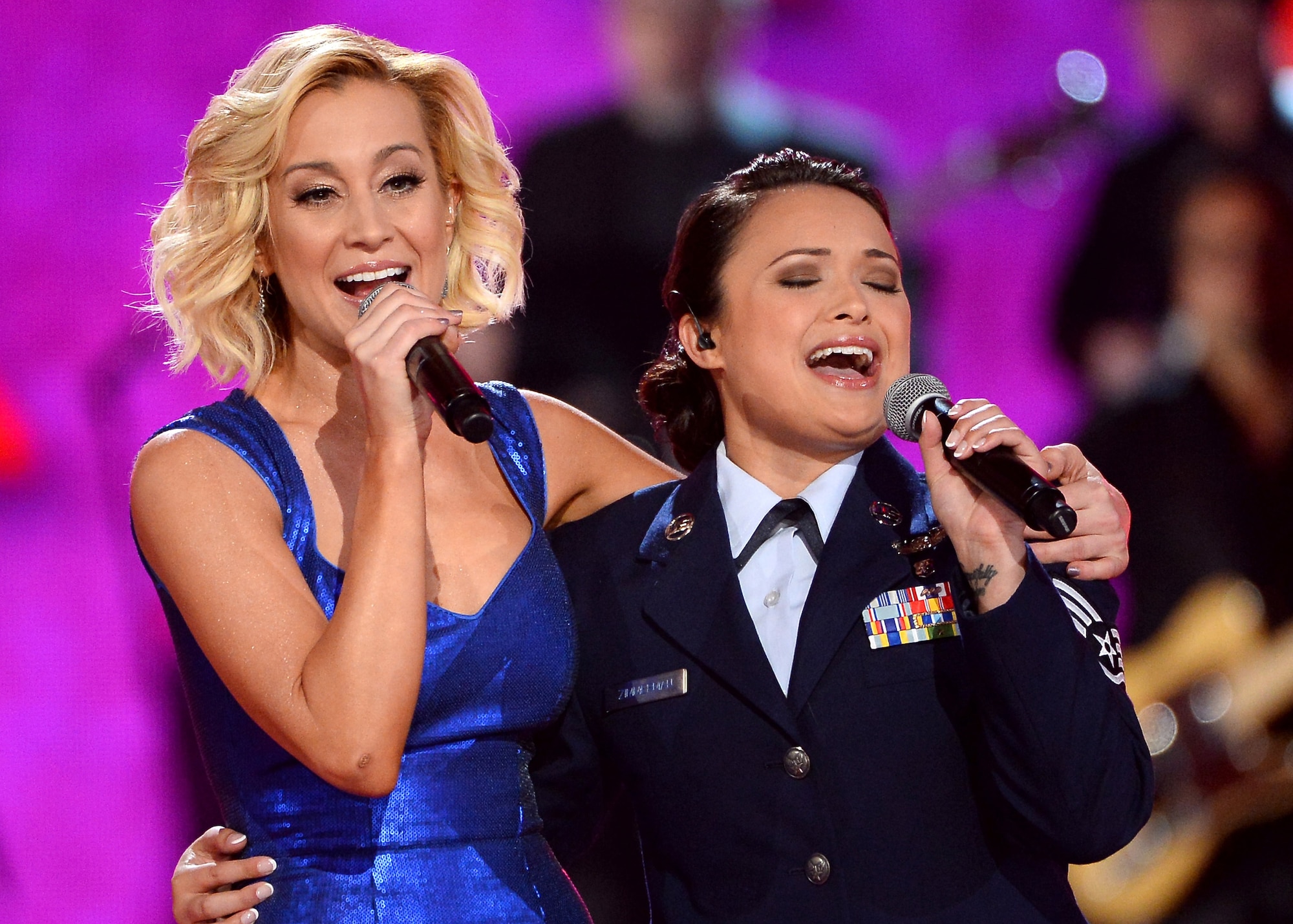 Singer Kellie Pickler, left, and Staff Sgt. Baily Zimmerman, an aircrew aerospace medical craftsman assigned to the 43rd Aeromedical Evacuation Squadron, Pope Army Airfield, Fort Bragg, N.C.,  perform onstage during ACM Presents: An All-Star Salute To The Troops at the MGM Grand Garden Arena on April 7, 2014 in Las Vegas, Nevada.  (Getty Images/ Courtesy of Academy of Country Music)
