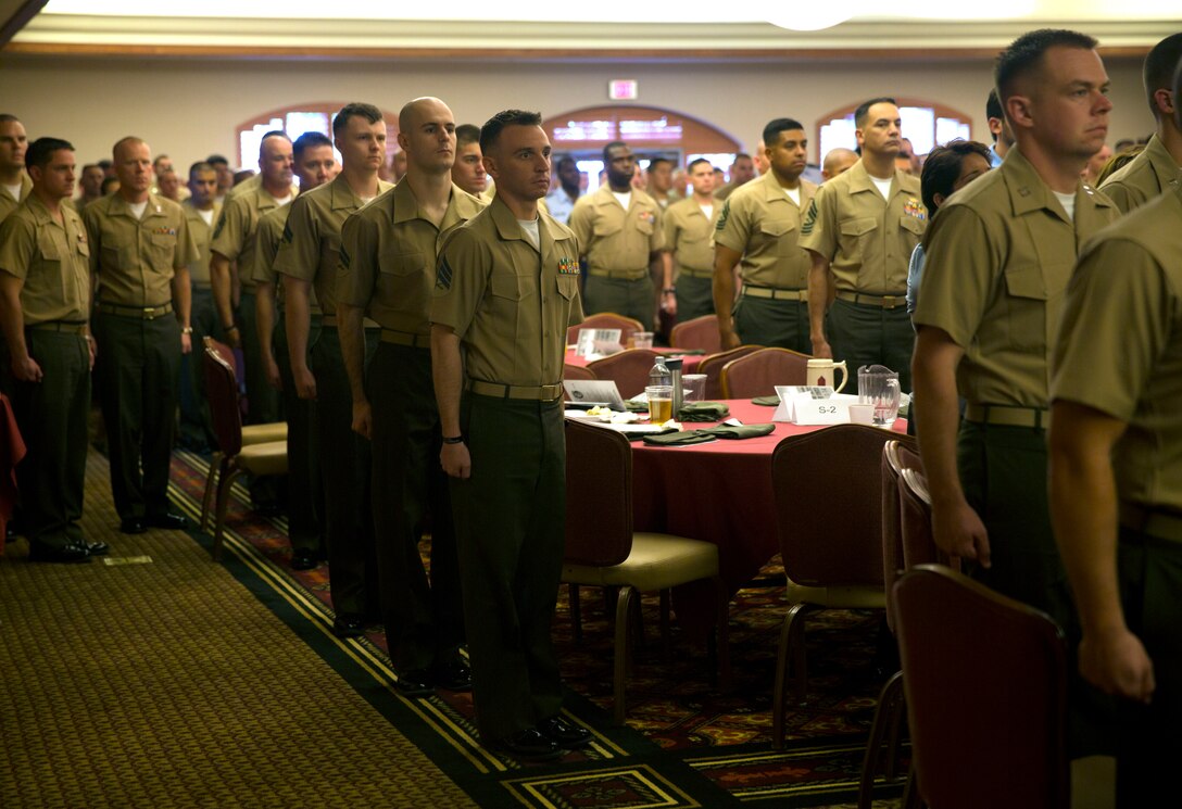 Marines filled the banquet room at the Sonoran Pueblo aboard Marine Corps Air Station Yuma, Ariz., April 27, for the Weapons and Tactics Instructor Course 2-14 graduation ceremony. Following the invocation read by Navy Lt. Keith Lightner, the chaplain for Marine Aircraft Group 13, the Marines came to attention as the National Anthem played during the Weapons and Tactics Instructor Course 2-14 graduation ceremony at the Sonoran Pueblo aboard Marine Corps Air Station Yuma, Ariz., April 27.