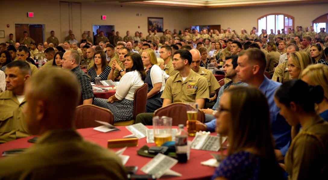 Hundreds of Marines, sailors, airmen and civilians listen attentively as the guest speaker, Lt. Gen. Jon M. Davis, Deputy Commander of United States Cyber Command, addresses the crowd during the Weapons and Tactics Instructor Course 2-14 graduation ceremony at the Sonoran Pueblo aboard Marine Corps Air Station Yuma, Ariz., April 27. 