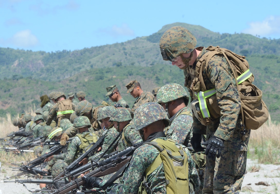 Philippine Marines from 2nd Marine Company, 11th Marine Battalion, and U.S. Marines from 1st Battalion, 8th Marine Regiment, work together during the first day of live-fire training May 6, 2014, at Crow Valley for Balikatan 2014. Balikatan is an annual training exercise that strengthens the interoperability between the Armed Forces of the Philippines and U.S. military in their commitment to regional security and stability, humanitarian assistance and disaster relief.