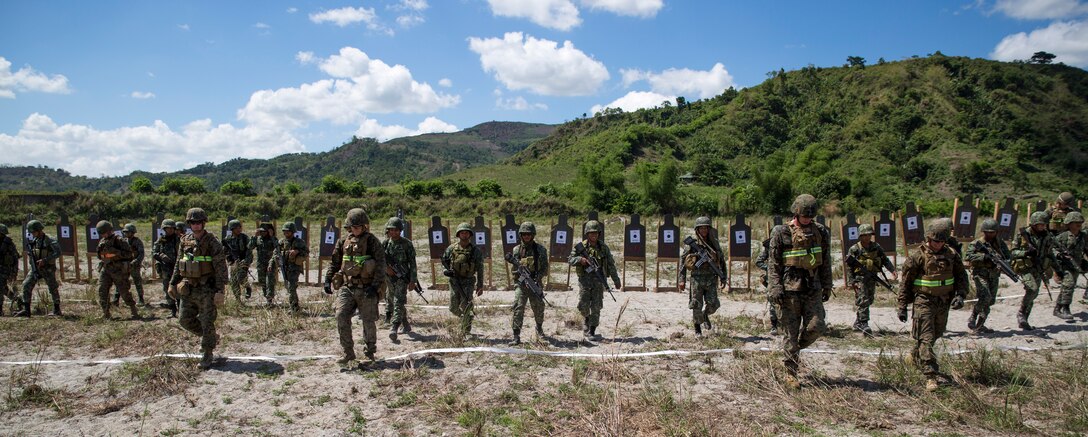 Philippine Marines assigned to 2nd Marine Company, 11th Marine Battalion, and U. S. Marines assigned to Charlie Company, 1st Battalion, 8th Marine Regiment, walk together after zeroing their rifles before execution of close-quarter marksmanship training May 6, 2014, at Crow Valley, Philippines, for Balikatan 2014. This marks the first day of several bilateral live-fire training evolutions for the exercise. Balikatan is an annual training exercise that strengthens the interoperability between the Armed Forces of the Philippines and U.S. military in their commitment to regional security and stability, humanitarian assistance and disaster relief. 