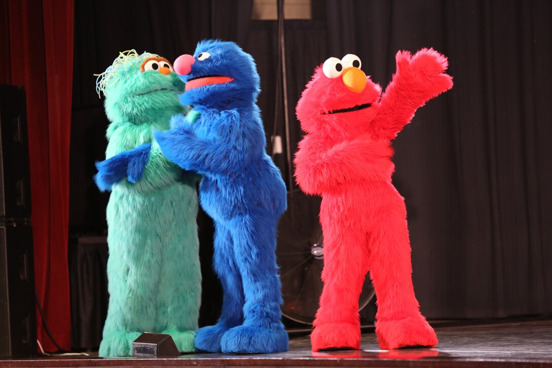 Sesame Street characters sing and dance during the Sesame Street USO Experience for Military Families at the Two Rivers Theater aboard Marine Corps Air Station Cherry Point April 27. The production is geared toward service members and their family preparing for deployments and permanent change of station.