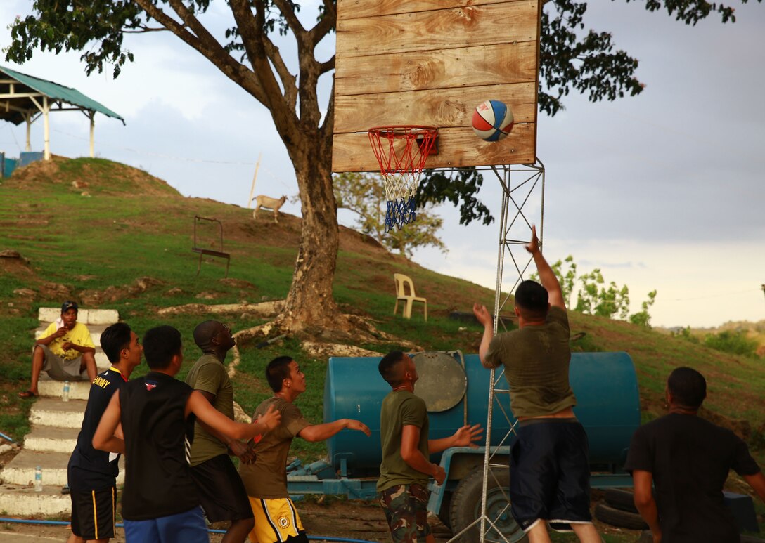 Members of the Philippine Air Force and U.S. Marine Corps compete in a friendly basketball match at Crow Valley, Philippines, May 5, 2014, to mark the end of the opening day of Balikatan 2014. Balikatan is an annual training exercise that strengthens the interoperability between the Armed Forces of the Philippines and U.S. military in their commitment to regional security and stability, humanitarian assistance and disaster relief.