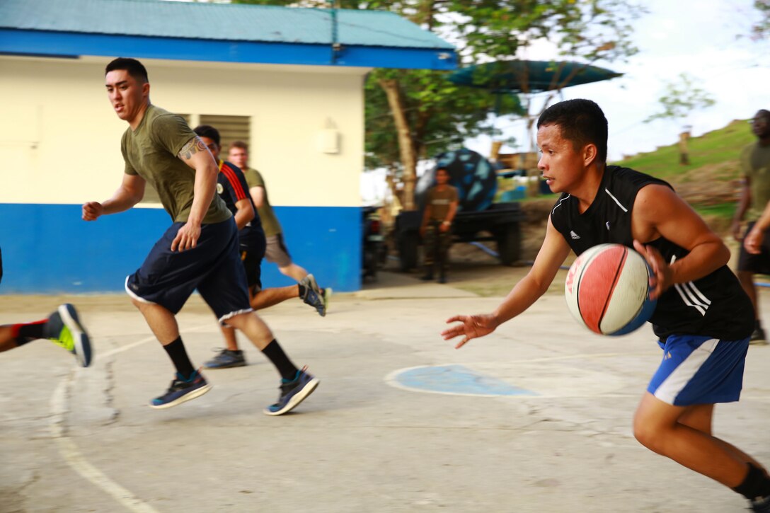 Members of the Philippine Air Force and U.S. Marine Corps compete in a friendly basketball match at Crow Valley, Philippines, May 5, 2014, to mark the end of the opening day of Balikatan 2014. Balikatan is an annual training exercise that strengthens the interoperability between the Armed Forces of the Philippines and U.S. military in their commitment to regional security and stability, humanitarian assistance and disaster relief.