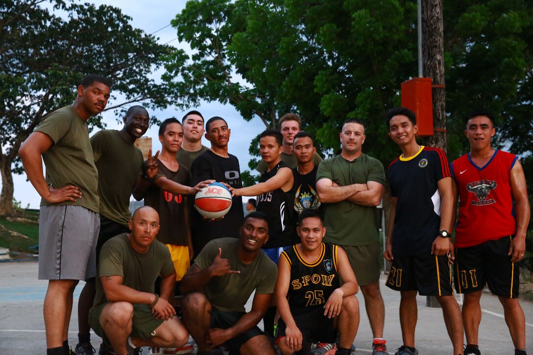 Members of the Philippine Air Force and U.S. Marine Corps pose for a group photo following a friendly basketball match at Crow Valley, Philippines, May 5, 2014, to mark the end of the opening day of Balikatan 2014. Balikatan is an annual training exercise that strengthens the interoperability between the Armed Forces of the Philippines and U.S. military in their commitment to regional security and stability, humanitarian assistance and disaster relief.