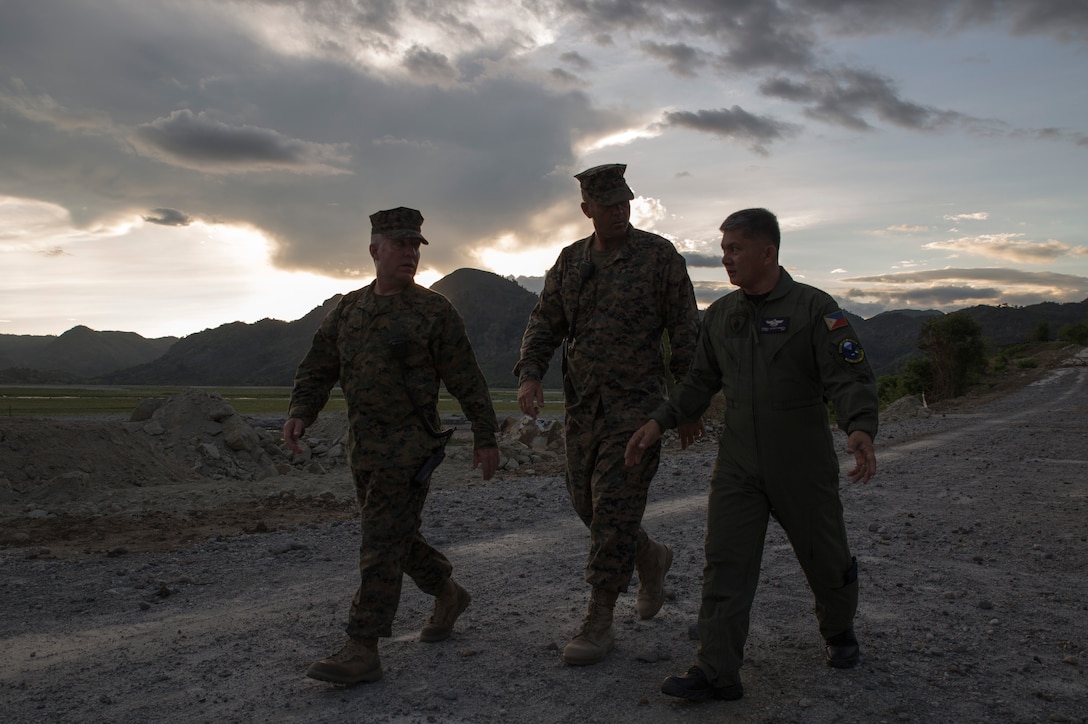 Philippine Air Force Lt. Col. Romell Allan P. Genete, right, the group commander of the 790th Air Base Group, walks with U.S. Marine Corps Chief Warrant Officer 3 Keith W. Earhart, left, and U. S. Marine Corps Master Sgt. Mark D. McLaughlin, center, to observe a road construction project in preparation for Balikatan 2014 at Crow Valley, Philippines May 4, 2014. The two nation’s militaries will participate in the exercise to increase interoperability and reinforce mission readiness. Earhart and McLaughlin are assigned to 3rd Maintenance Battalion, Combat Logistics Regiment 35, 3rd Marine Logistics Group, III Marine Expeditionary Force.