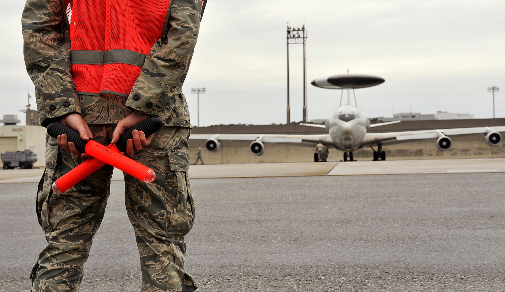 U.S. Air Force Senior Airman Robyne Keller, 961st Aircraft Maintenance Unit crew chief, waits to marshal an E-3 Sentry Airborne Warning and Control System aircraft on Kadena Air Base, Japan, May 6, 2014, before take off in support of exercise RED FLAG-Alaska 14-1. Since its inception in 1975, thousands of people from all four branches of the U. S. military have taken part in multi-national exercises. (U.S. Air Force photo by Naoto Anazawa)

