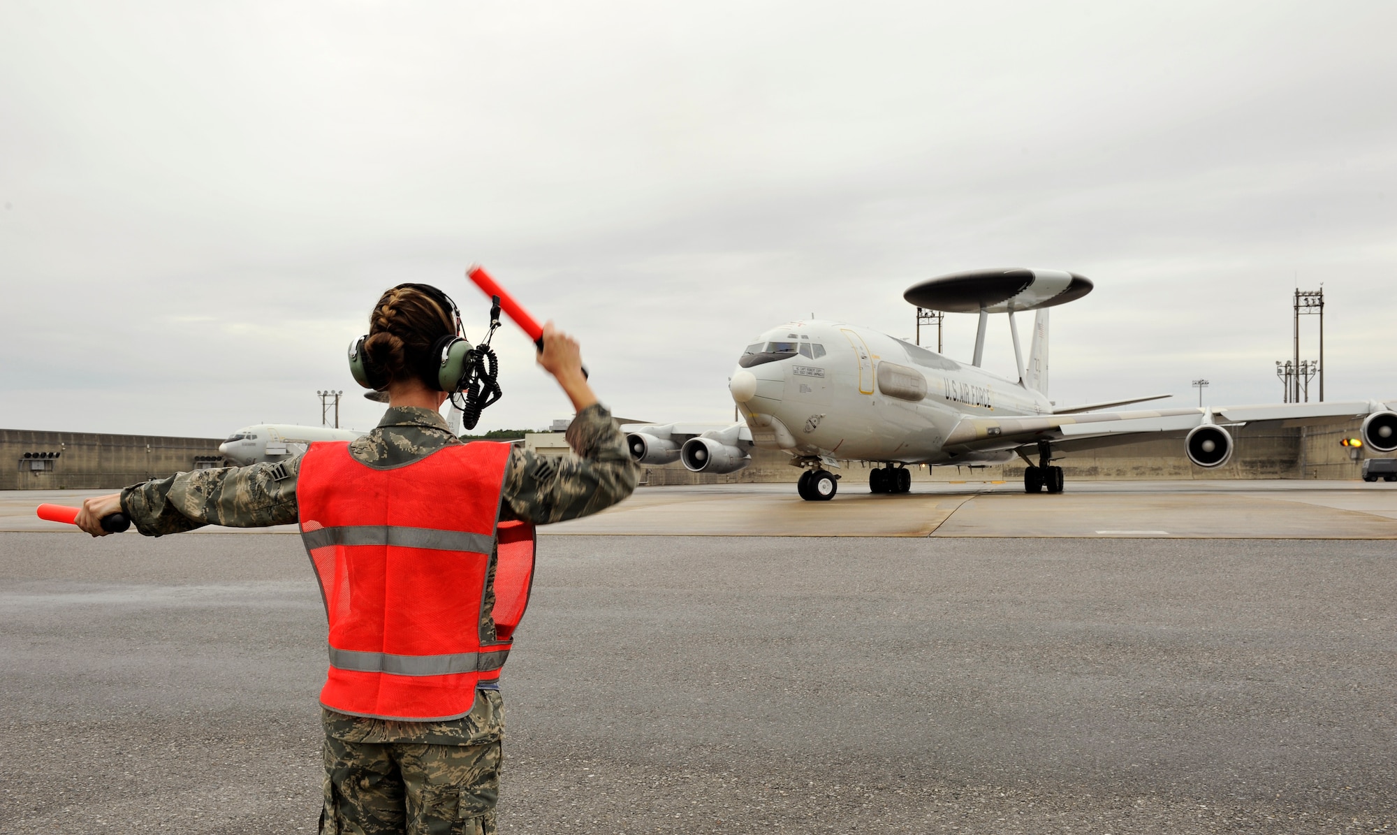 U.S. Air Force Senior Airman Robyne Keller, 961st Aircraft Maintenance Unit crew chief, marshals an E-3 Sentry Airborne Warning and Control System aircraft on Kadena Air Base, Japan, May 6, 2014, launching in support of exercise RED FLAG-Alaska 14-1. RF-A is a realistic, 10-day air combat U. S. Air Force training exercise held up to four times a year at Eielson and Joint Base Elmendorf-Richardson Air Force Base in Alaska. (U.S. Air Force photo by Naoto Anazawa)
