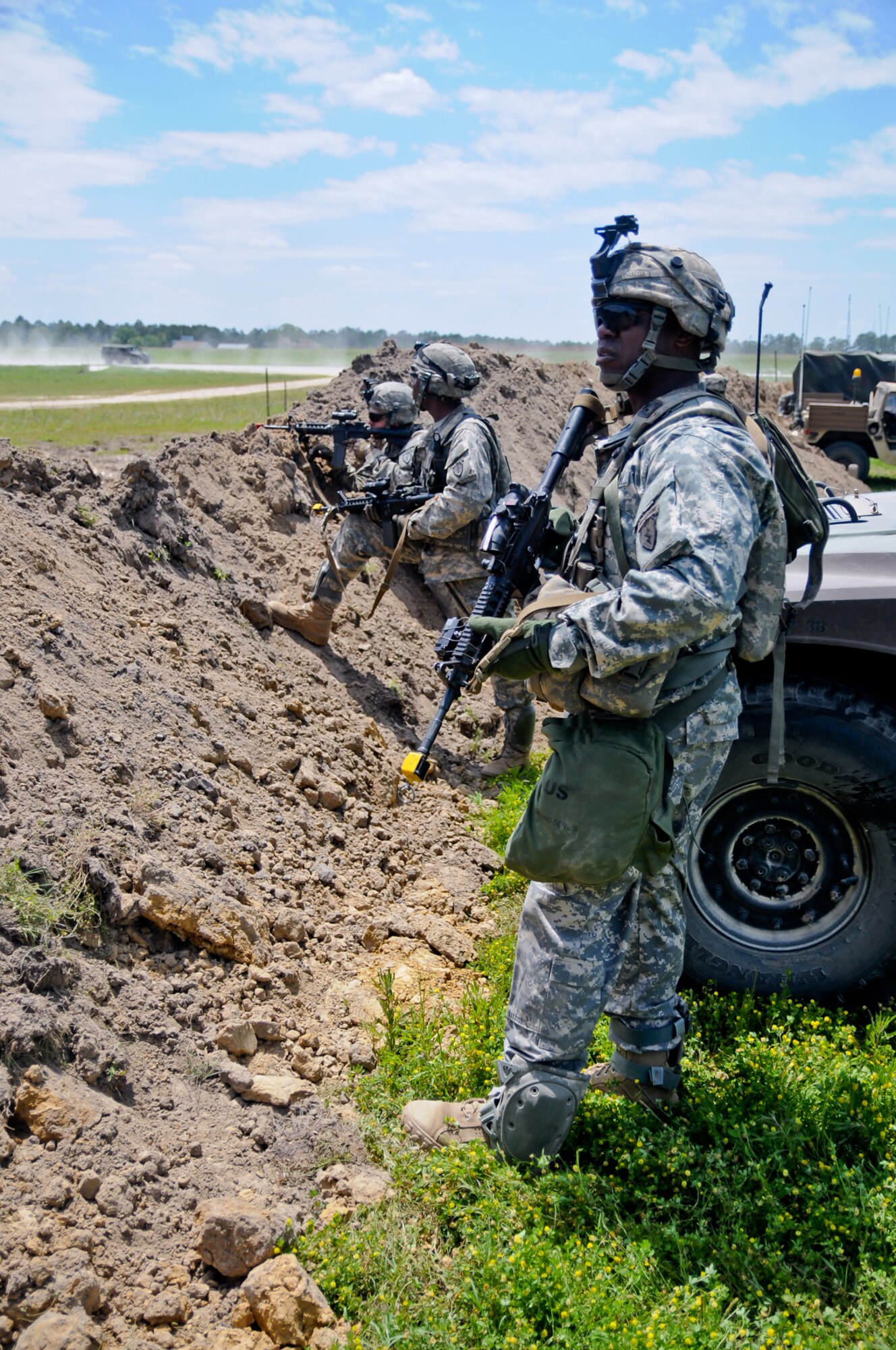 Army 1st Sgt. Darrell Webster (foreground), the first sergeant for Headquarters and Headquarters Battery, 2nd Battalion, 377th Parachute Field Artillery Regiment, checks the perimeter line during a react-to-contact exercise at the Joint Readiness Training Center April 22 at Fort Polk, La. (U.S. Army photo/Sgt. Eric-James Estrada)
