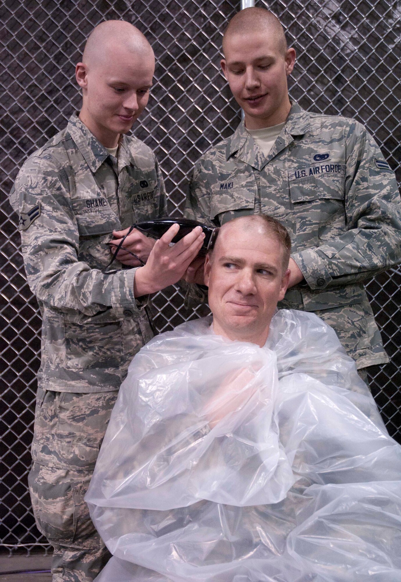 Airmen 1st Class Eric Maki and Airman 1st Class Joshua Shaner, 90th Logistics Readiness Squadron of Lt. Col. Chad Ellsworth, 90th LRS commander, during a commander’s call May 8 in the Personnel Deployment Facility. (U.S. Air Force photo by Airman Malcolm Mayfield)