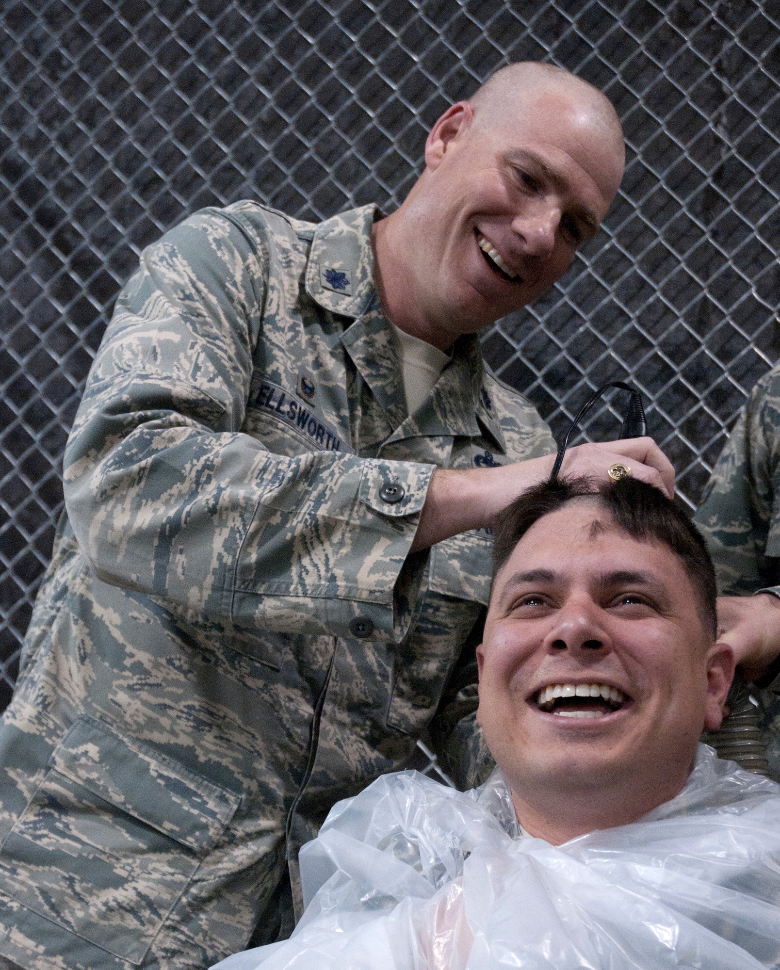 Lt. Col. Chad Ellsworth, 90th Logistics Readiness Squadron commander, gives Capt. Christopher Dupuis, 90th LRS operations officer, a haircut during a commander’s call May 8 in celebration of the squadrons three year mark for no DUIs in the Personnel Deployment Facility. Ellsworth will have his change of command ceremony in June leaving the reward for next year’s milestone up to the new commander. (U.S. Air Force photo by Airman Malcolm Mayfield)