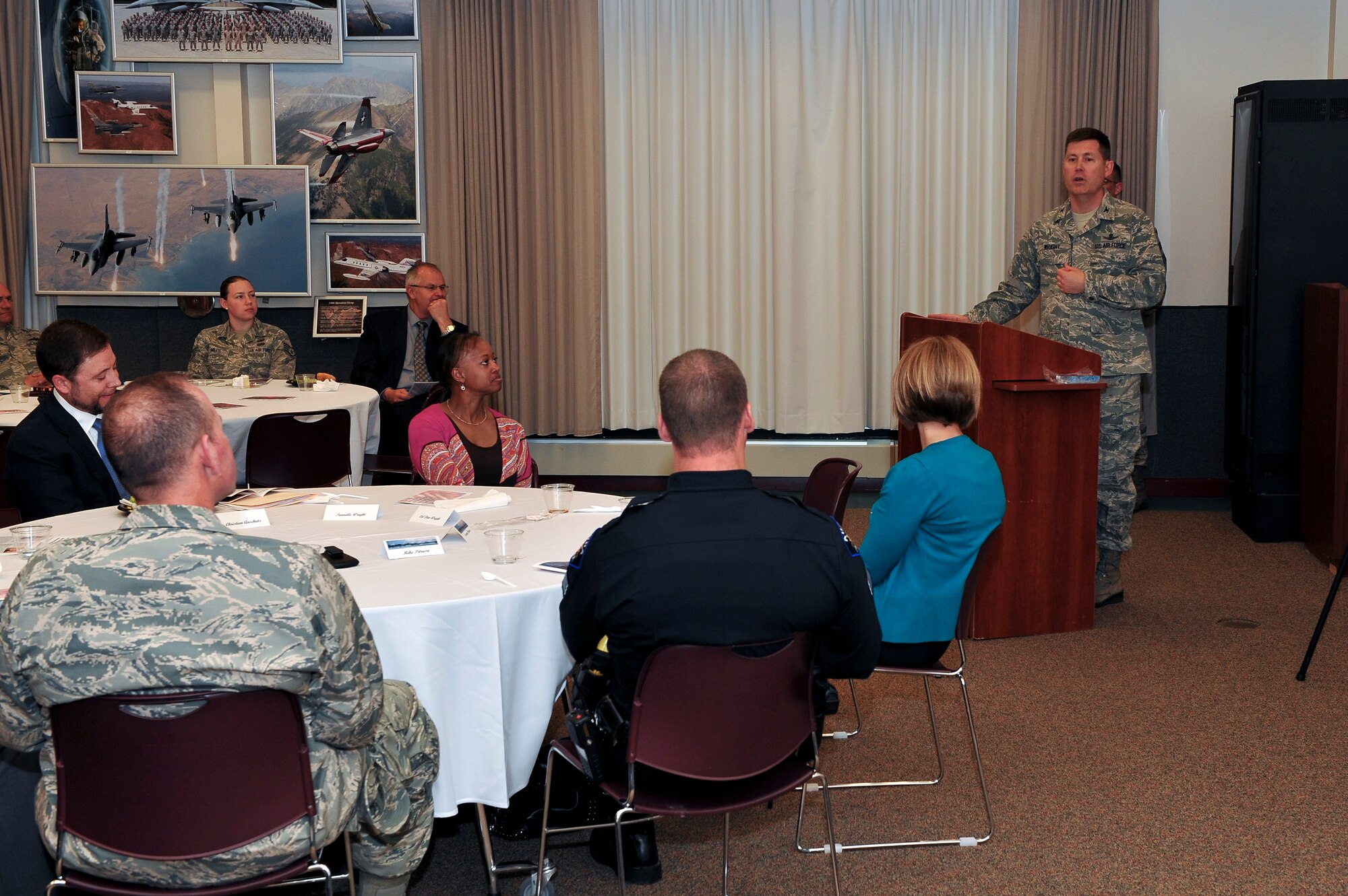 Col. Dan Wright, 460th Space Wing commander, introduces Suzanne Pitrusu the 5th community member to be recognized with the Community Heroes of Buckley Award May 8, 2014, at the 140th Headquarters Building on Buckley Air Force Base, Colo. The CHOB program was started in 2011 as a way to recognize community leaders for their outstanding service to Team Buckley. (U.S. Air Force photo by Senior Airman Phillip Houk/Released)