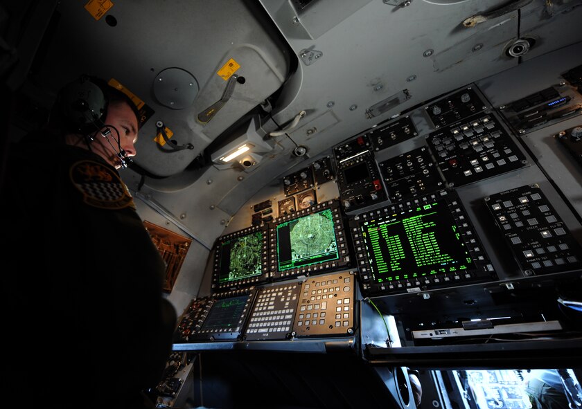 U.S. Air Force Maj. Brad Weber, 337th Test and Evaluation Squadron, defensive weapons operator, checks a screen in the cockpit of a B-1B Lancer that displays diagnostic information May 7, 2014, at Dyess Air Force Base, Texas. The aircraft recently received three different upgrades, including a Fully Integrated Data Link, a Vertical Situation Display upgrade, and a Central Integrated System upgrade. The VSDU upgrades the B-1's forward cockpit by replacing two unsupportable, monochrome pilot and co-pilot displays with four multifunctional color displays, giving pilots more situational awareness data in a user-friendly format. (U.S. Air Force photo by Airman 1st Class Alexander Guerrero/Released)