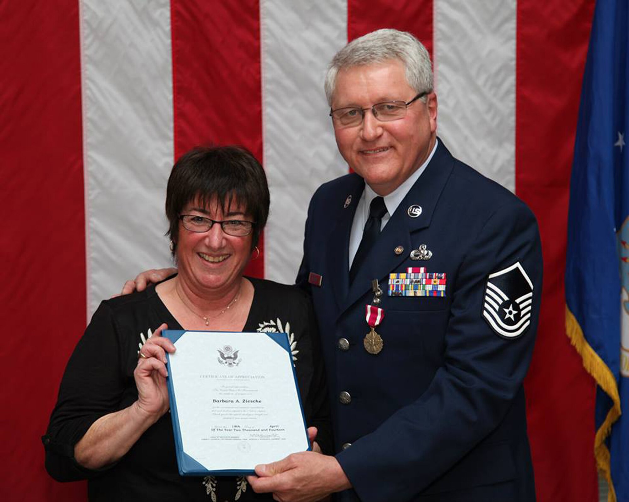 TRAVIS AIR FORCE BASE, Calif. -- Master Sgt. Richard Ziesche, supervisor of safety, 349th Maintenance Group, with his wife, Barbara during a retirement ceremony April 27, 2014 at Travis Air Force Base, Calif. Col. M. J. (Sonny) Giddings, Jr., 349th Air Mobility Wing, was the officiating officer. (U.S. Air Force photo/Lt. Col. Robert Couse-Baker)
