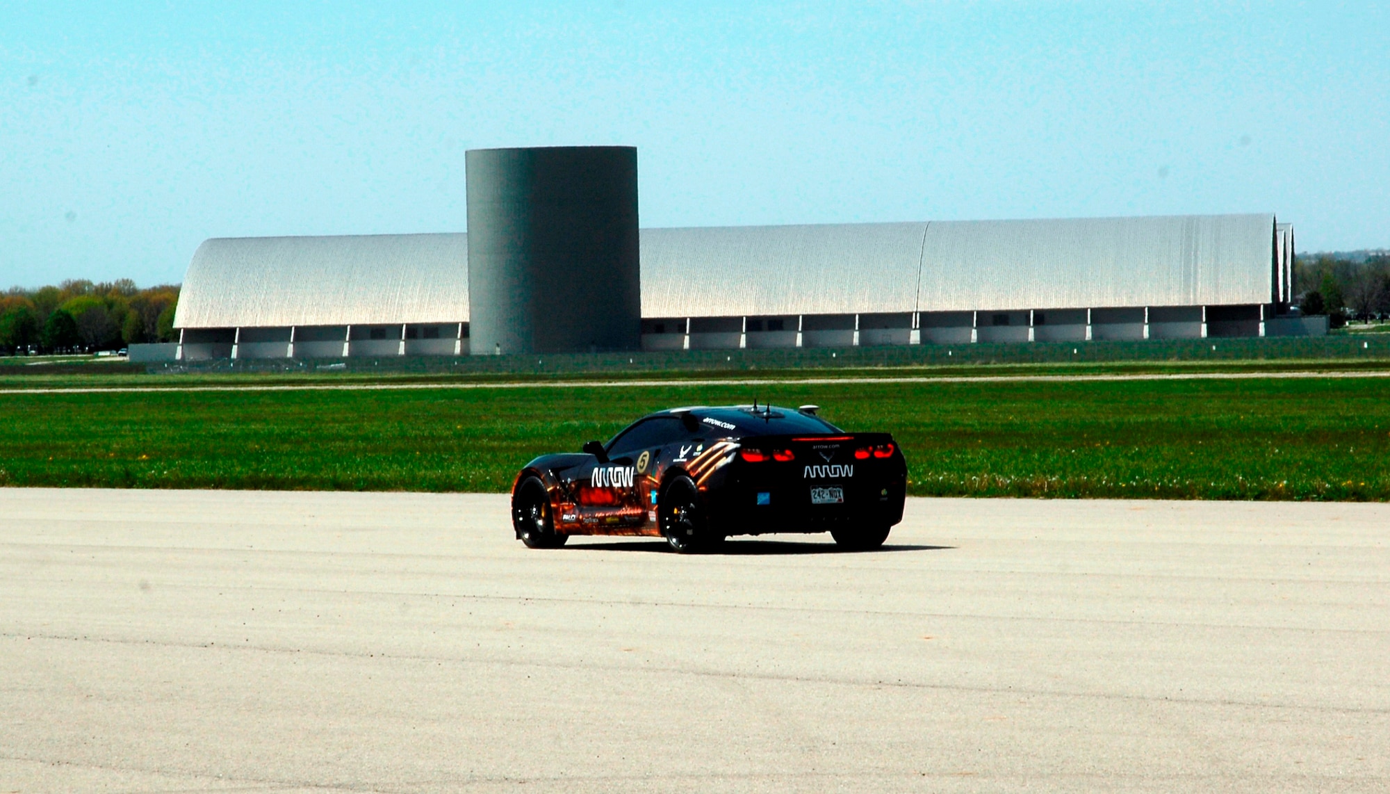 Sam Schmidt drives the 2014 Corvette C7 Stingray car down the runway next to the National Museum of the United Starts Air Force.  Schmidt demonstrated his ability to control the car. (USAF photo by Al Bright)