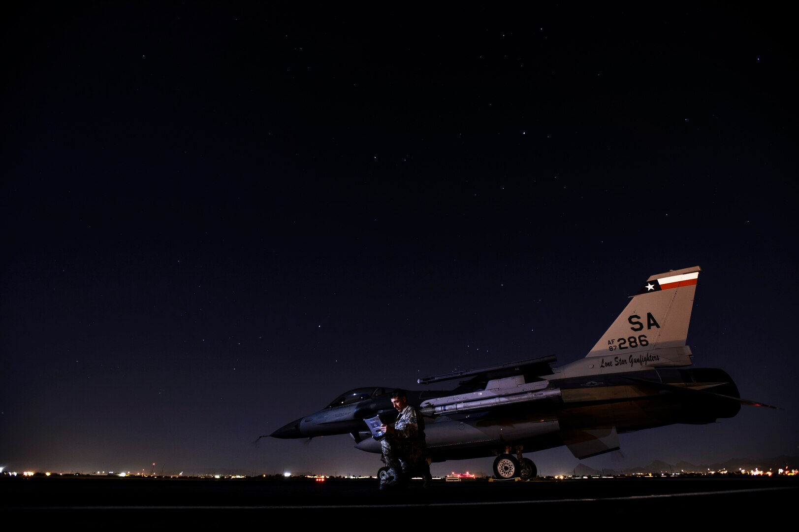Tech Sgt. Larry Esquivel, 149th Aircraft Maintenance Squadron electroenvironmental technician, reviews technical orders for an F-16C Fighting Falcon at Davis-Monthan Air Force Base, Ariz., April 13, 2014. Coronet Cactus exercise provides realistic combat training for student fighter pilots from air-to-air combat to dropping inert and live ordnance. (U.S. Air Force photo/ Staff Sgt. Jonathan Snyder)