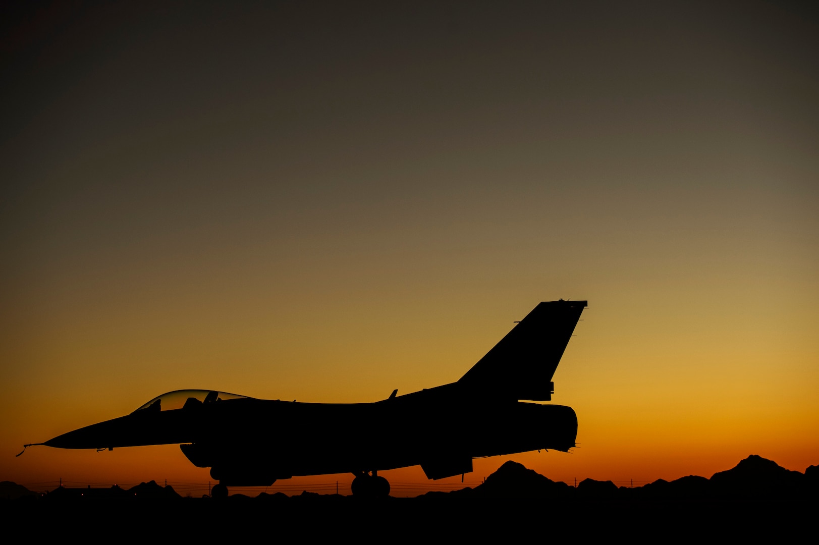 An F-16C Fighting Falcon, 182nd Fighter Squadron, sits on the ramp until the next training mission at Davis-Monthan Air Force Base, Ariz., April 13, 2014. Coronet Cactus exercise provides realistic combat training for student fighter pilots from air-to-air combat to dropping inert and live ordnance. (U.S. Air Force photo/ Staff Sgt. Jonathan Snyder)