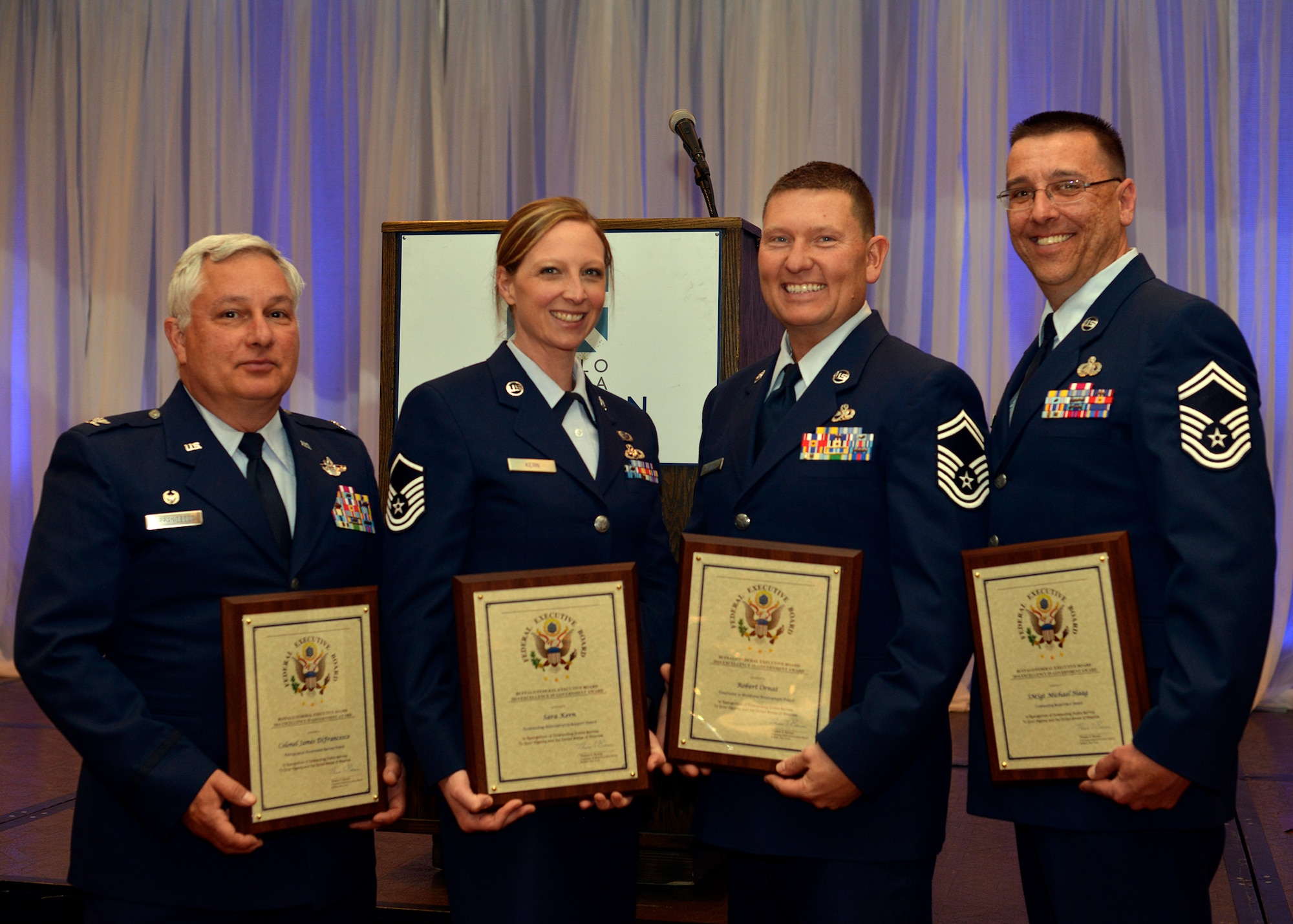 914th Airlift Wing members, Col. James DiFrancesco, Master Sgt. Sara Kern, Senior Master Sgt. Robert Ornat, and Senior Master Sgt. Michael Haag pose with awards they received from the Buffalo Federal Executive Board, during a ceremony held at the Buffalo Convention Center, May 6, 2014, Buffalo, N.Y. The Buffalo Federal Executive Board annually recognizes federal employees who exemplify “excellence in public service.” (U.S. Air Force photo by Tech. Sgt. Joseph McKee)