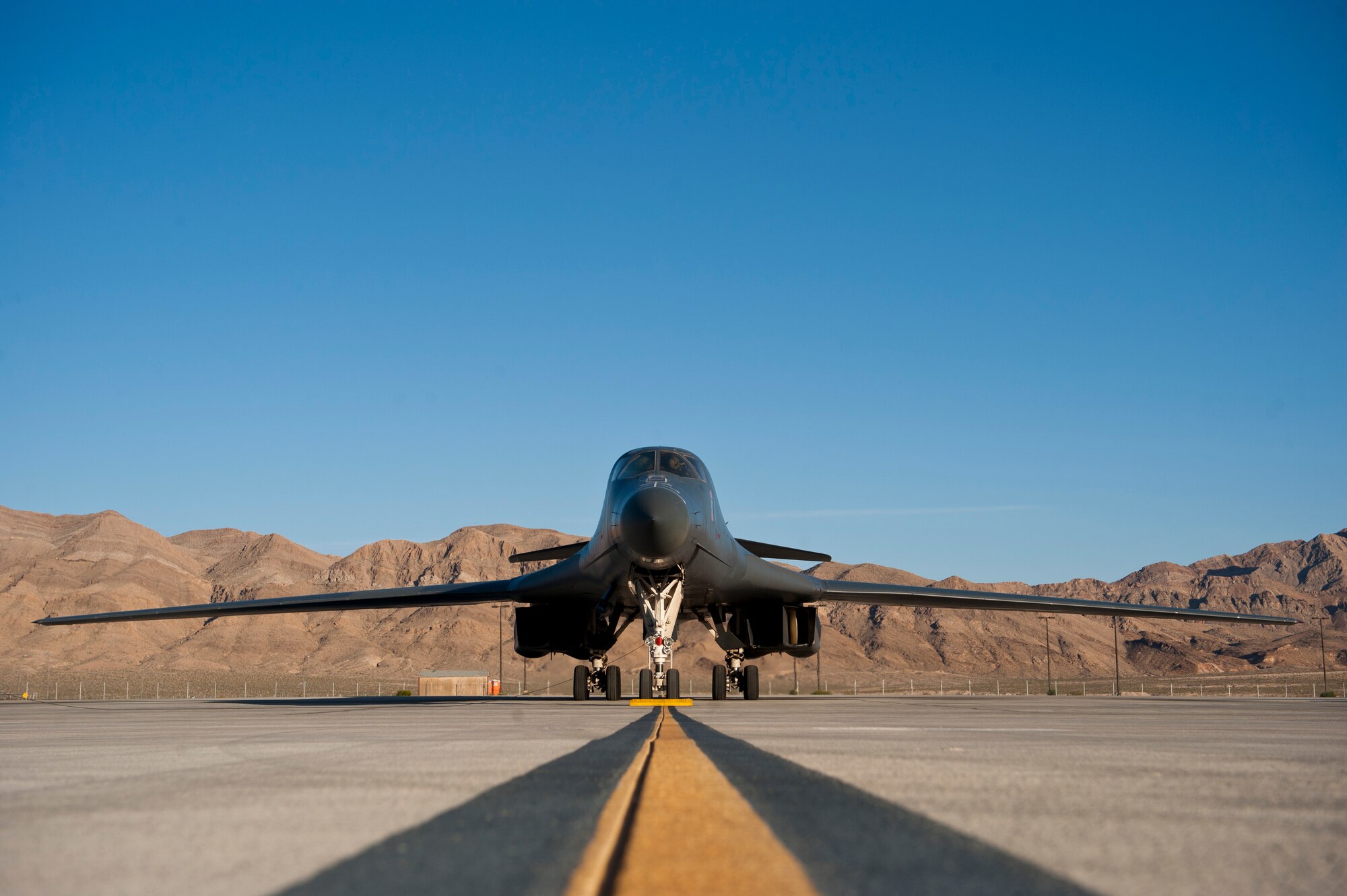 A U.S. Air Force B-1B Lancer assigned to the 7th Bomb Wing, Dyess Air Force Base, Texas, waits to taxi to the runway during Green Flag 14-6 April 24, 2014, at Nellis Air Force Base, Nev. The B-1B Lancer is a multi-role bomber aircraft capable of carrying a 75,000-pound payload and delivering precision and non-precision weapons on any target in the world at any time. (U.S. Air Force photo by Airman 1st Class Thomas Spangler/Released)