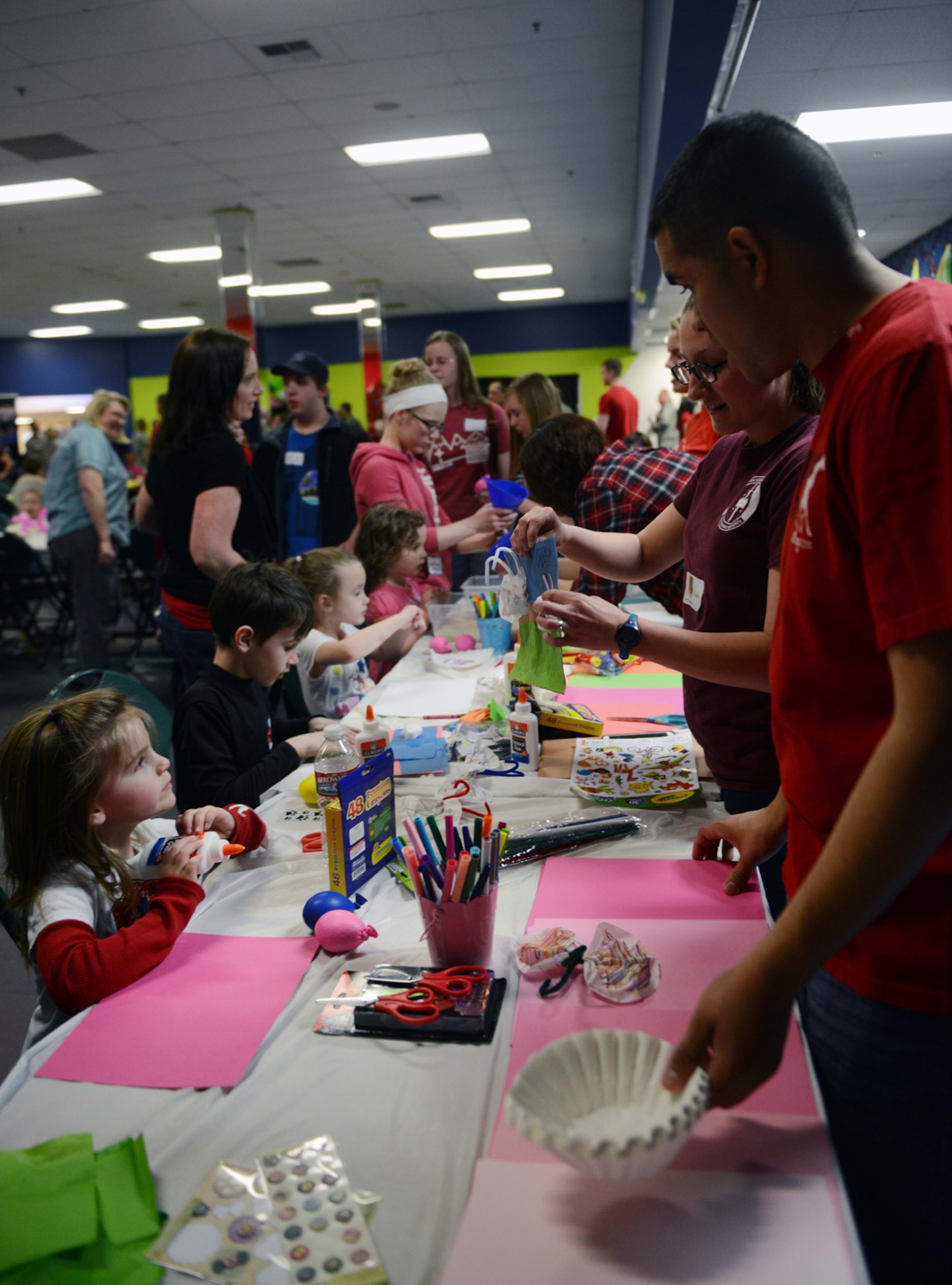 JOINT BASE ELMENDORF-RICHARDSON?Volunteer Airmen create arts and crafts with children of deployed military members during the deployed spouses dinner at the Arctic Oasis on Joint Base Elmendorf-Richardson, Alaska, April 30, 2014. Airmen from squadrons across the installation also provided coordination for the event with games and decorations. (U.S. Air Force photo/Airman 1st Class Ty-Rico Lea)