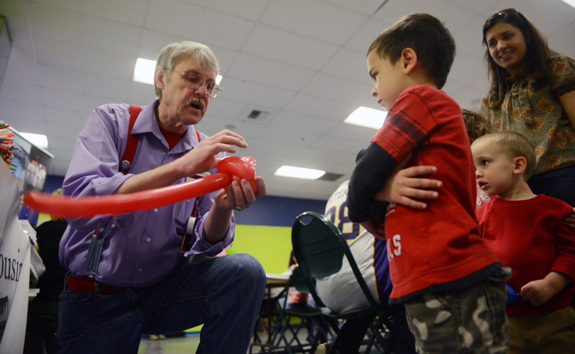 JOINT BASE ELMENDORF-RICHARDSON?Tom Underwood makes balloon animals for children during the deployed spouses dinner at the Arctic Oasis on Joint Base Elmendorf-Richardson, Alaska, April 30, 2014. More than 50 spouses and dependents were served at the event. (U.S. Air Force photo/Airman 1st Class Ty-Rico Lea)