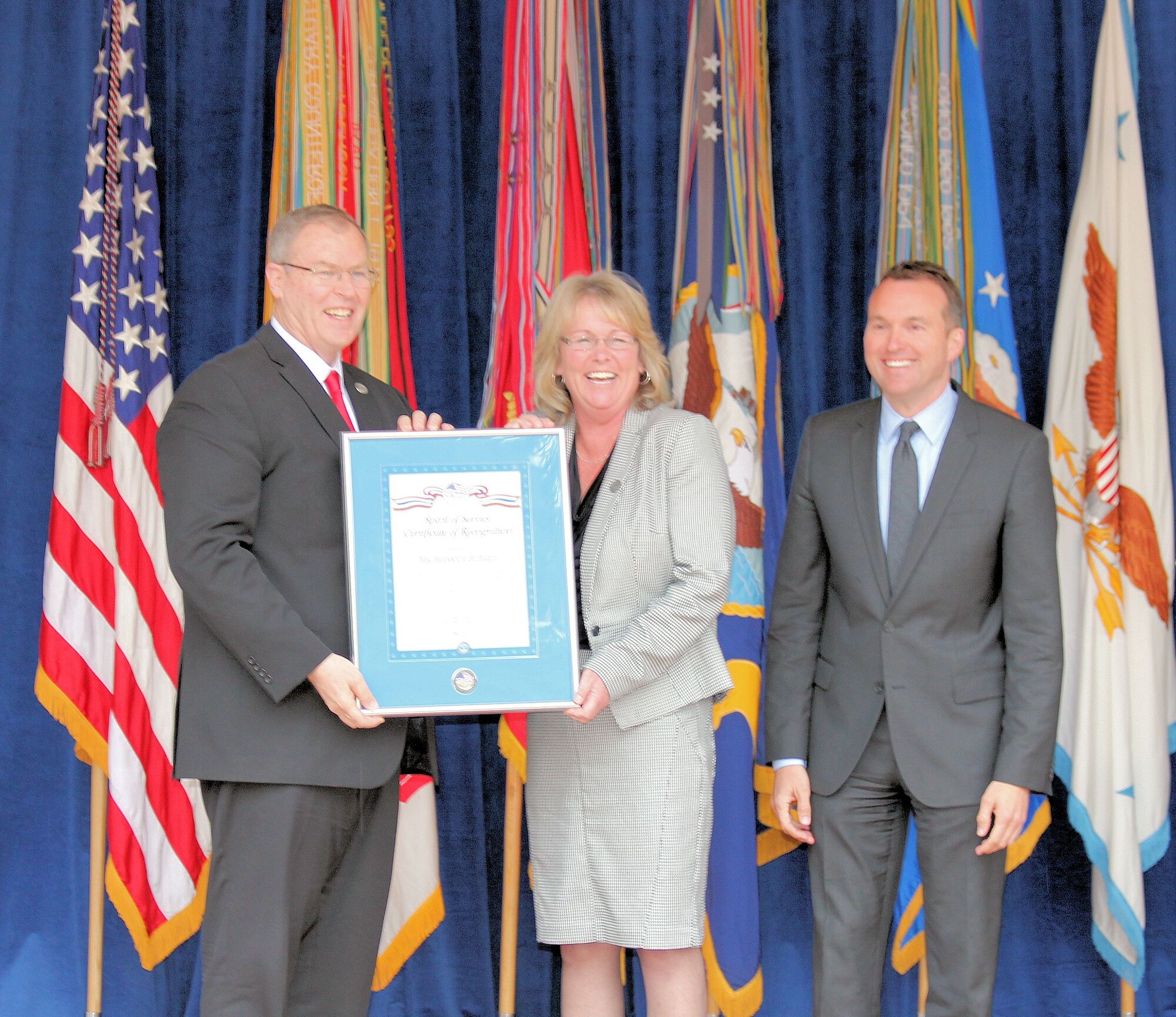 Rebecca Buffalini, medial inquiries specialist, Congressional and Public
Affairs Office, Air Force Surgeon General, receives the Spirit of Service
award May 7 from Deputy Defense Secretary Robert Work (left), and
Undersecretary of the Air Force Eric Fanning during the awards ceremony at
the Pentagon courtyard. 
