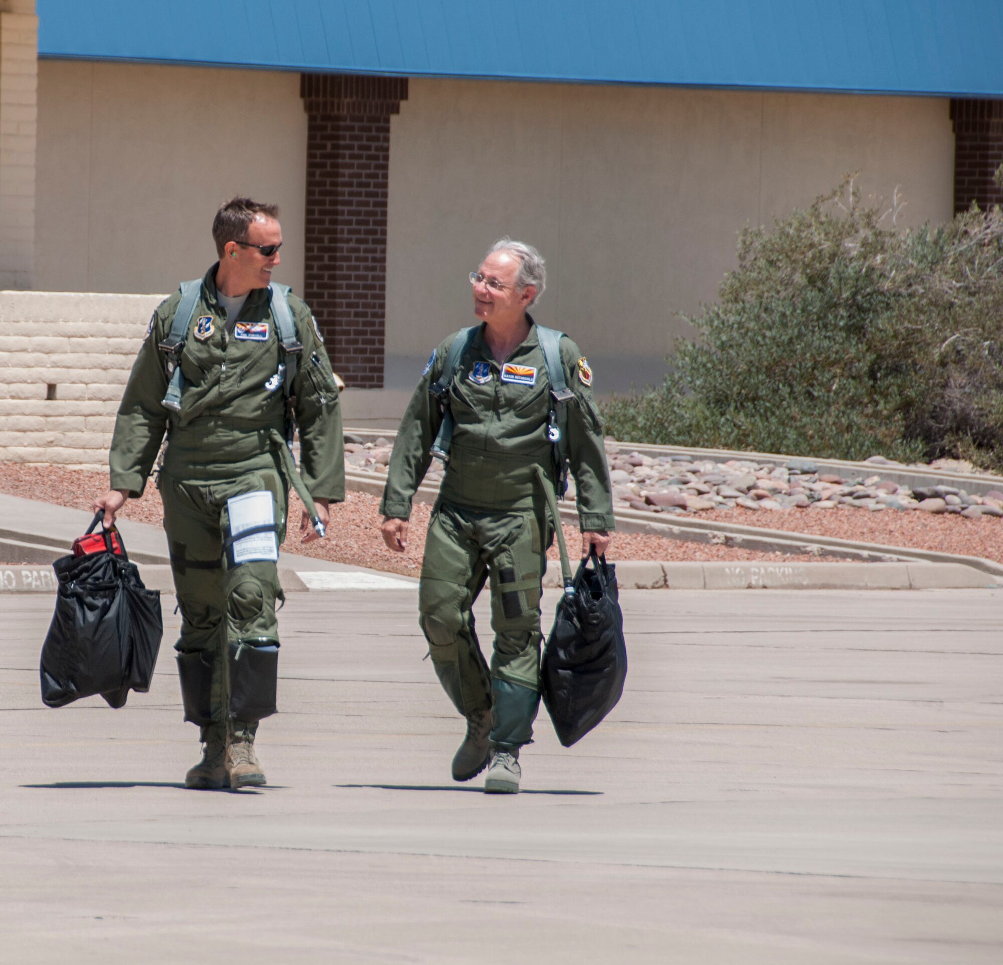 Jonathan Rothschild, Mayor of Tucson and Col. Phil Purcell, Commander of the 162nd Wing, proudly stride toward an awaiting F-16 Falcon, on May 3.  Rothschild was invited to the 162nd Wing to participate in an orientation flight, which raises awareness and understanding about the wing's mission. (U.S. Air National Guard photo by Staff Sgt. Dina Farmer/Released)