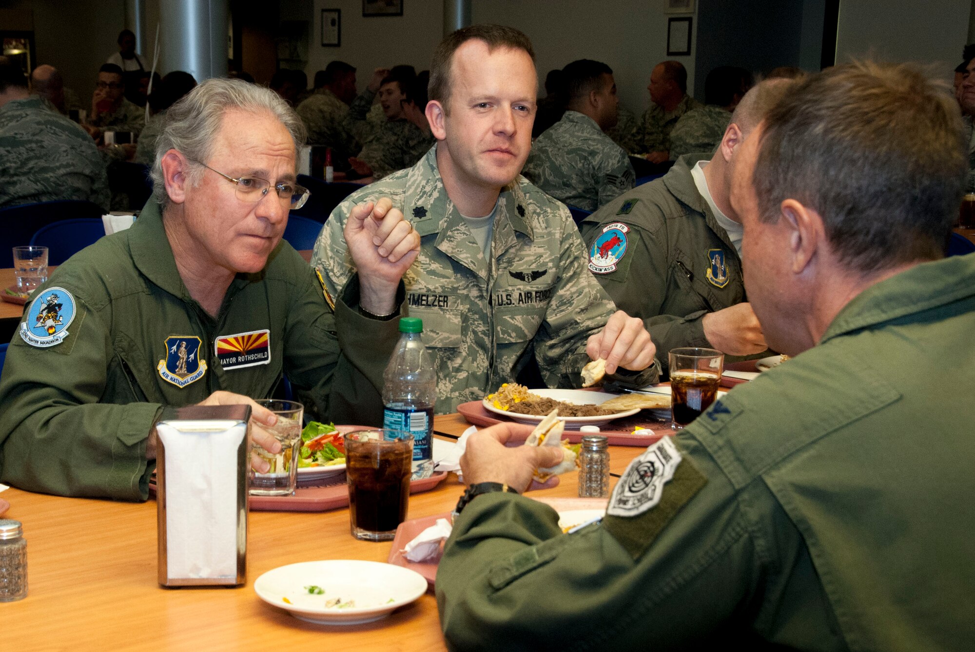 Jonathan Rothschild, Mayor of Tucson, discusses wing concerns with Lt. Col. Christopher Schmelzer and Col. Howard "Phil" Purcell, commander of the 162nd Wing, while having lunch at the dining facility at the 162nd Wing May 3.  Rothschild was invited to the 162nd Wing to participate in an orientation flight, which raises awareness and understanding about the wing’s mission.  (U.S. Air National Guard photo by Tech. Sgt. Hollie Hansen/Released)