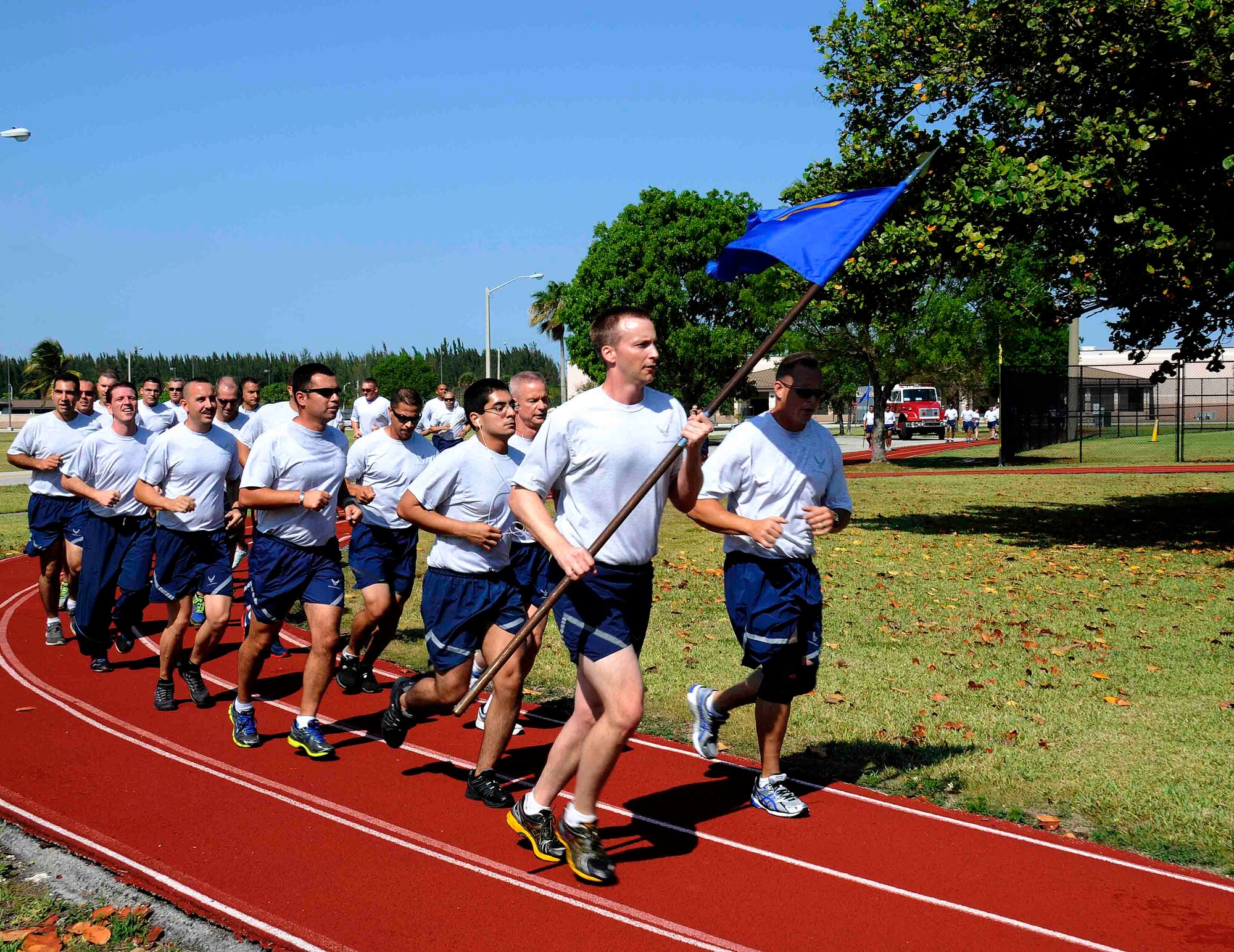 Airmen from the 70th Aerial Port Squadron as well as from other squadrons run a 5K on the track behind the Sam Johnson Fitness Center at Homestead Air Reserve Base, Fla., May 4. The 70th APS held a Port Dawg 5K as an inaugural memorial to honor fallen members of Aerial Port Squadrons around the world. (U.S. Air Force photo/Senior Airman Nicholas Caceres))