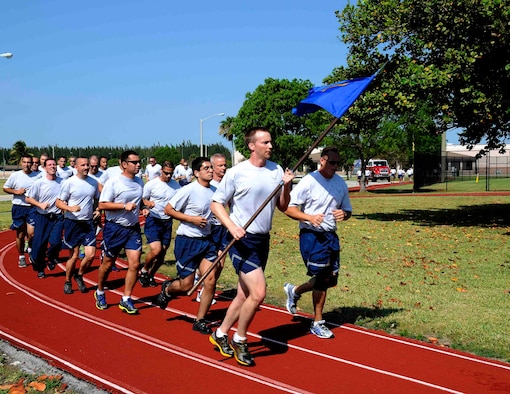 Airmen from the 70th Aerial Port Squadron as well as from other squadrons run a 5K on the track behind the Sam Johnson Fitness Center at Homestead Air Reserve Base, Fla., May 4. The 70th APS held a Port Dawg 5K as an inaugural memorial to honor fallen members of Aerial Port Squadrons around the world. (U.S. Air Force photo/Senior Airman Nicholas Caceres))