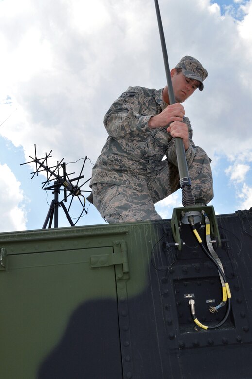 Air Force Staff Sgt. Kyle Garner, 682nd Air Support Operations Squadron, mounts an antenna to an ASOC Gateway vehicle during Warfighter 14-04 exercise, April 9, Fort Bragg, N.C. The Warfighter is a command post training exercise, designed and led by the Mission Command Training Program at Fort Leavenworth, Kansas, which simulates scenarios units might encounter in war. The exercises are designed to challenge commanders and their staffs to be both tactical and academic in their approach to wartime decision making. The state-of-the-art ASOC Gateway shortens the kill chain, reduces humanistic error and improves situational awareness for pilots, aircrew and joint terminal attack controllers. The ASOC is the primary command and control agency for integrating joint air power with Army operations. Fighter duty technicians coordinate air support for the JTACs and provide airspace de-confliction for tasked aircraft. Once JTACs receive a handoff of aircraft from the ASOC, it's their job to direct the fighters to the correct targets within close proximity to ground forces using radios and communications equipment. (U.S. Air Force photo/Marvin Krause)