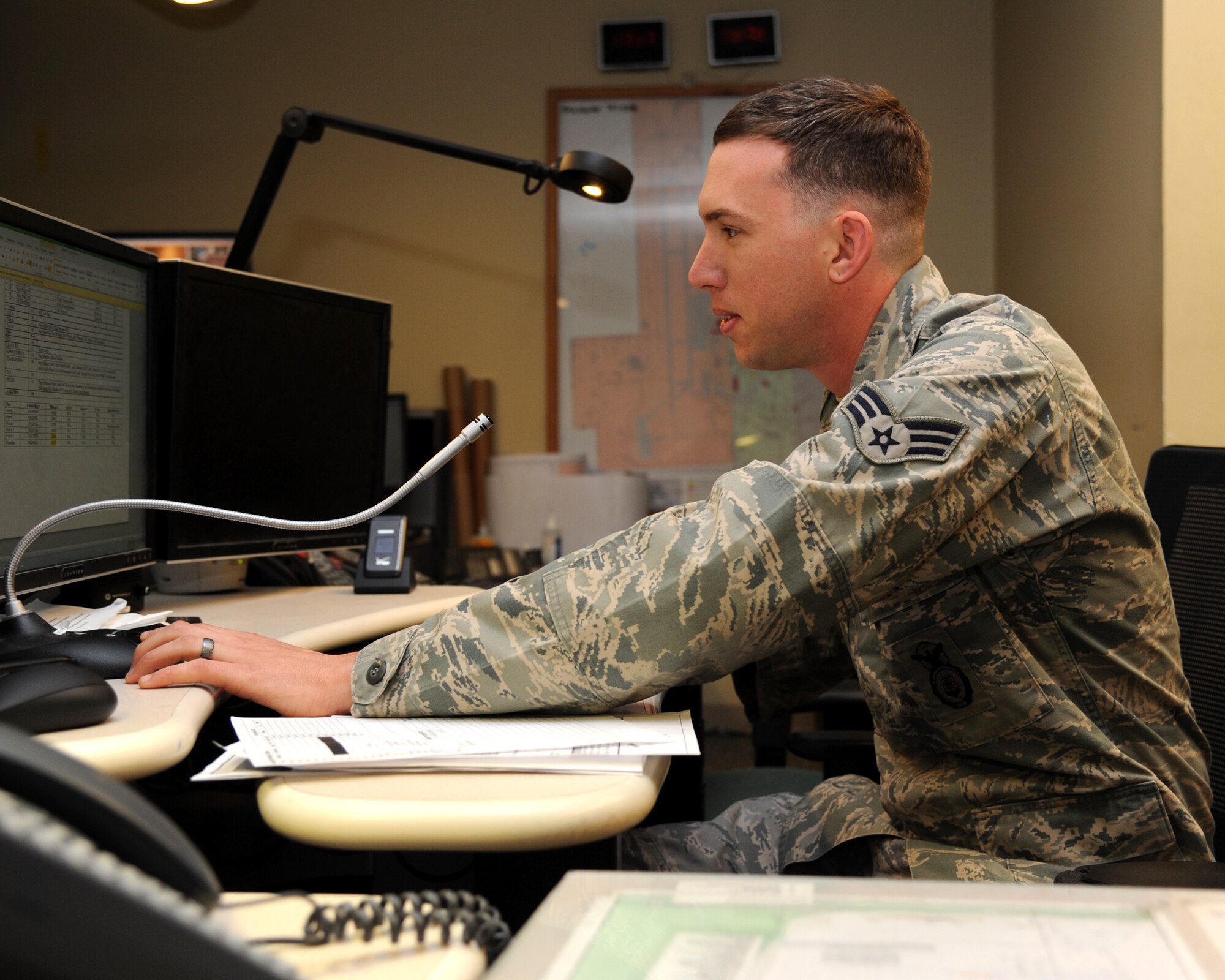 Senior Airman Matthew Alsup, 319th Security Forces Squadron desk sergeant, responds to queries from other security forces members May 8, 2014, at the law enforcement desk on Grand Forks Air Force Base, N.D. Alsup was named the warrior of the week for the second week of May. (U.S. Air Force photo/Senior Airman Zachiah Roberson)