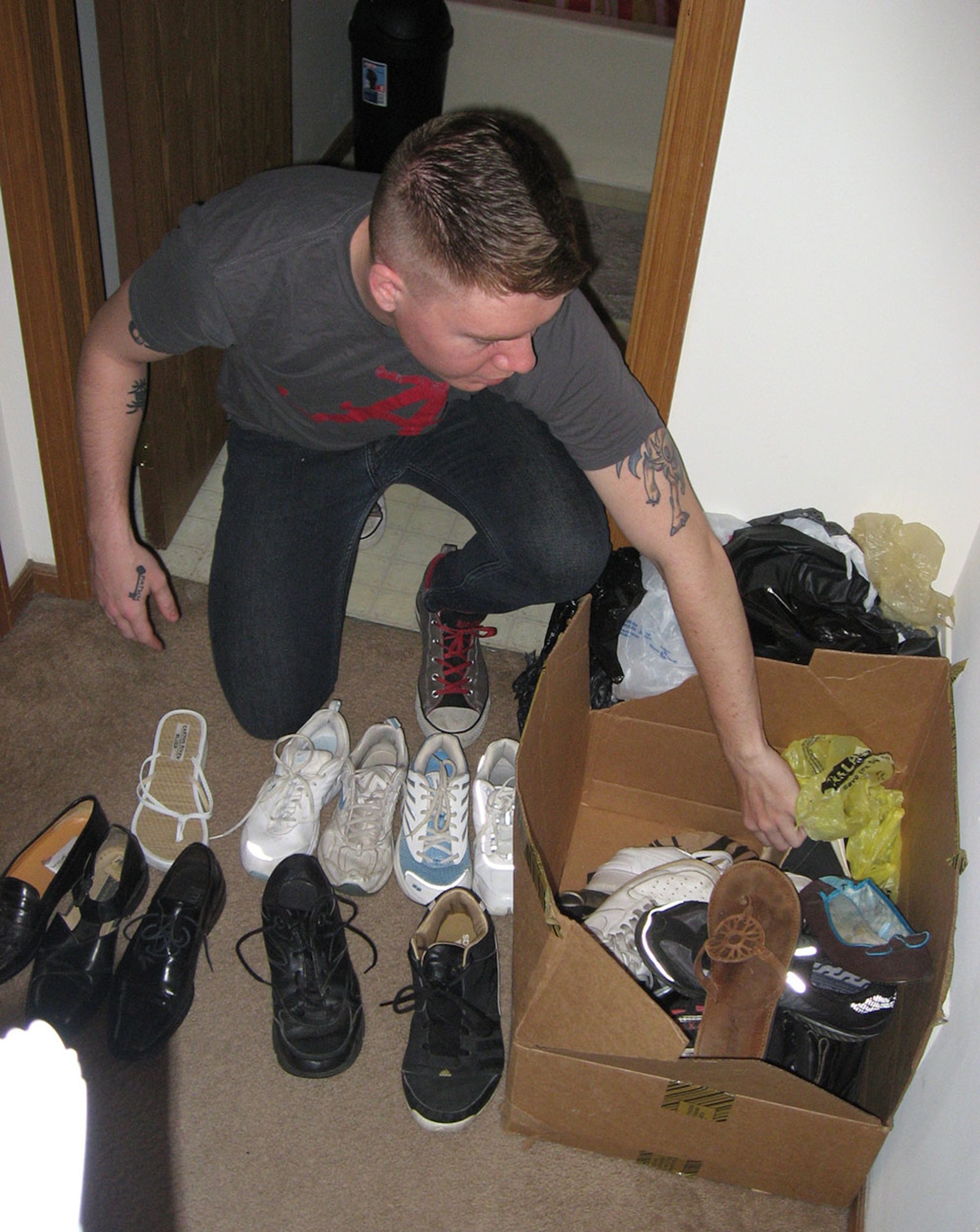 A1C Ian Hooper from NASIC pairs up donated shoes to be bagged as part of the Soles4Souls shoe drive. (photo by Ted Theopolos)